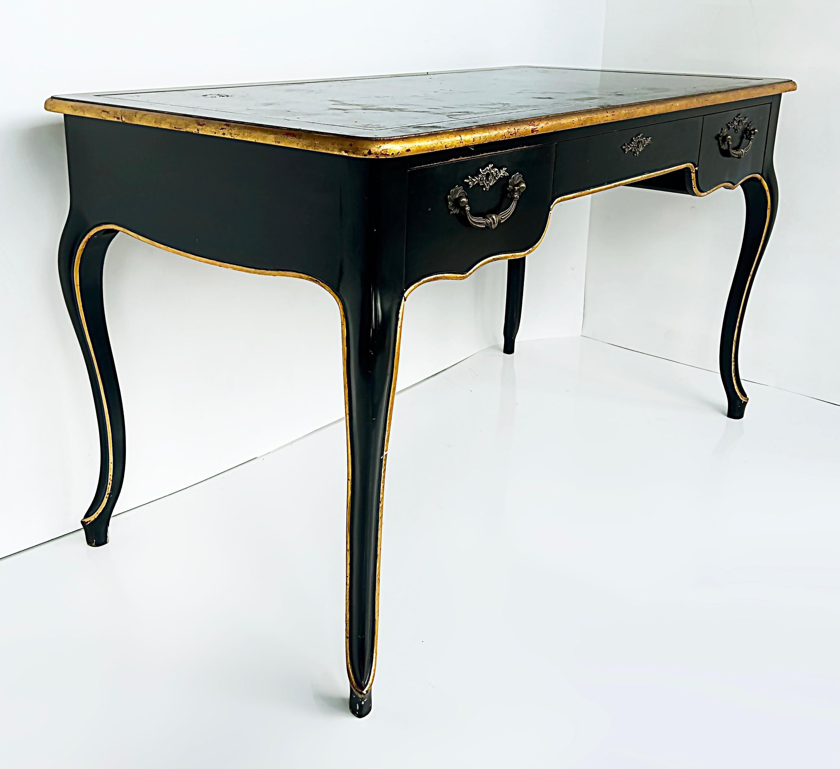 Vintage Baker Writing Desk, Ebonized Parcel Gilt with Leather Embossed

Offered for sale is a Baker Furniture Company writing desk in the French Bureau Plat Louis XV style. The desk has an ebonized parcel gilt finish with an embossed gilt leather