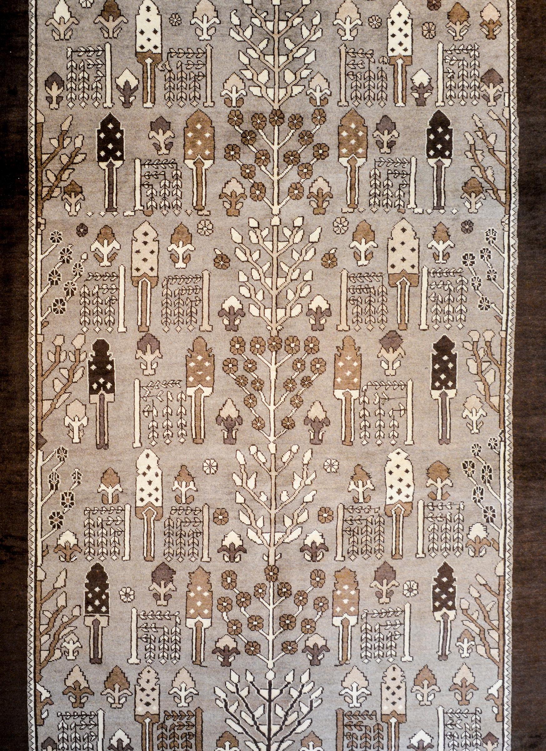 A beautiful vintage, mid-20th century, Persian Bakhtiari rug with a garden pattern consisting of myriad trees, shrubs, and flowering vines, all woven in natural, un-dyed, brown, grey, and beige colored wool.