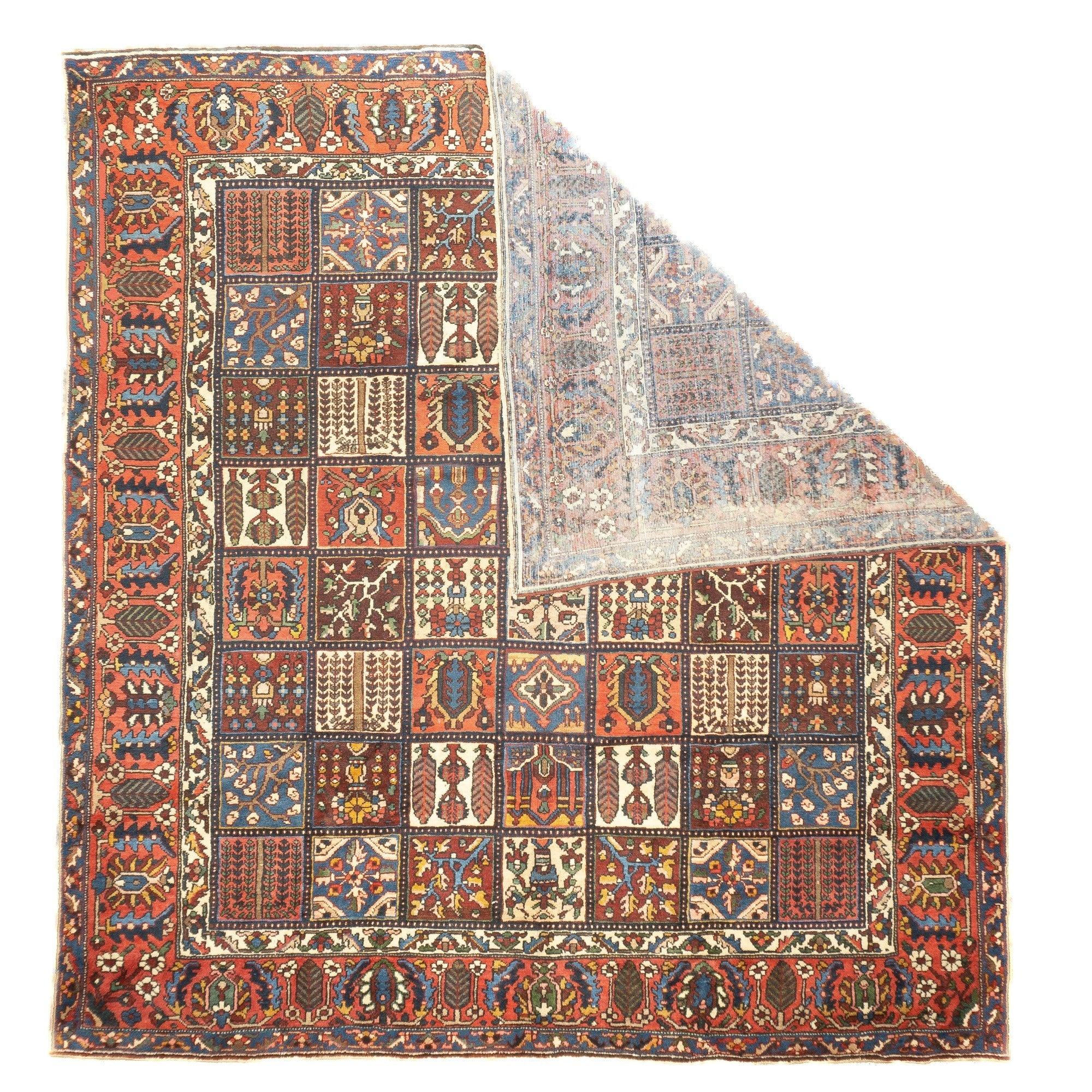 Vintage Bakhtiari Rug 9'11'' x 10'6''. The field is divided into a seven by eight array of squares depicting vignettes including: cypresses, weeping willows, oblique flowering branches, vases and medallions, all in shades of cream, red, dark blue,