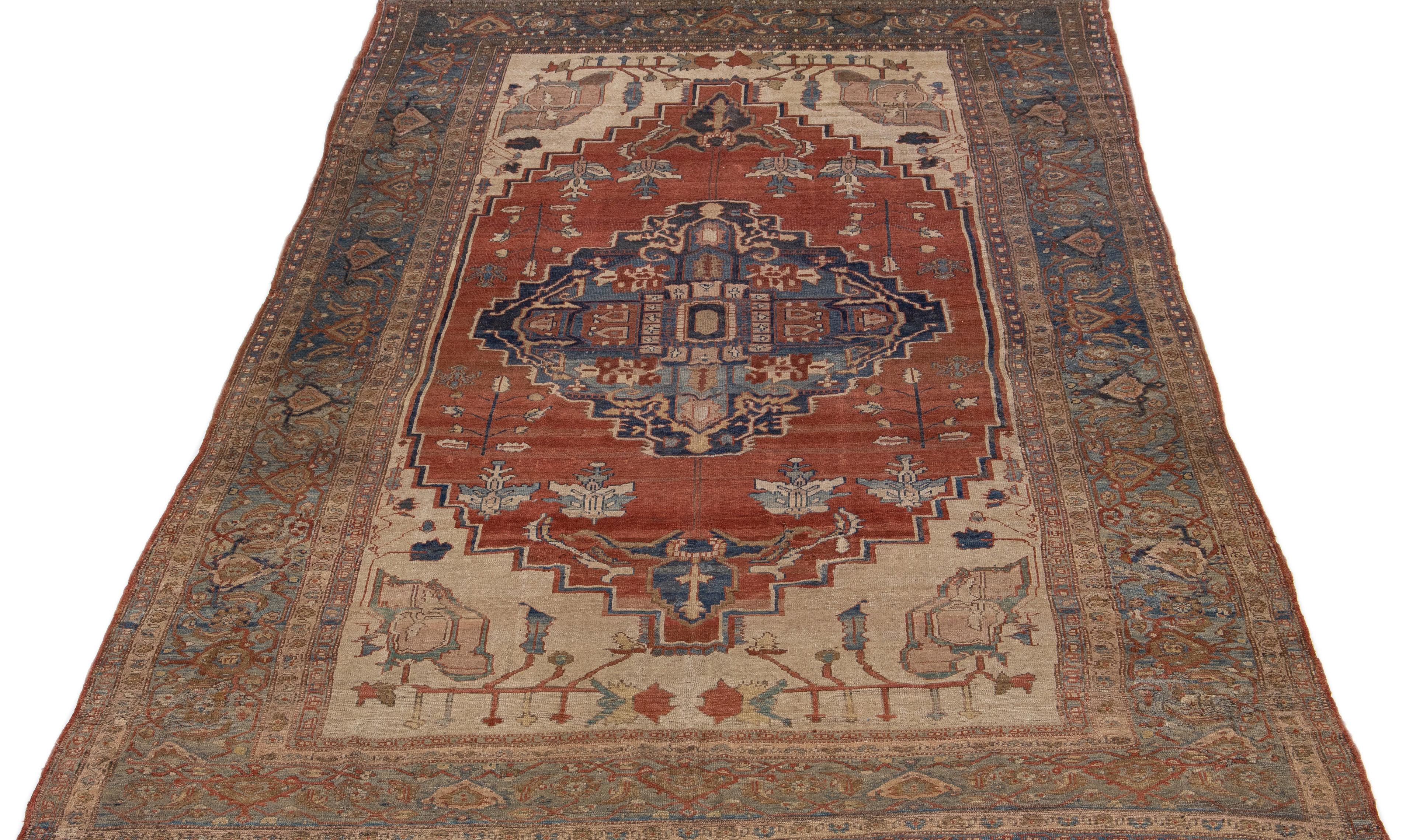 Beautiful vintage Bakshaish hand-knotted wool rug with a blue & rust color field. This Persian rug has the fame of blue and beige accents in an all-over geometric medallion design.

This rug measures 9'7