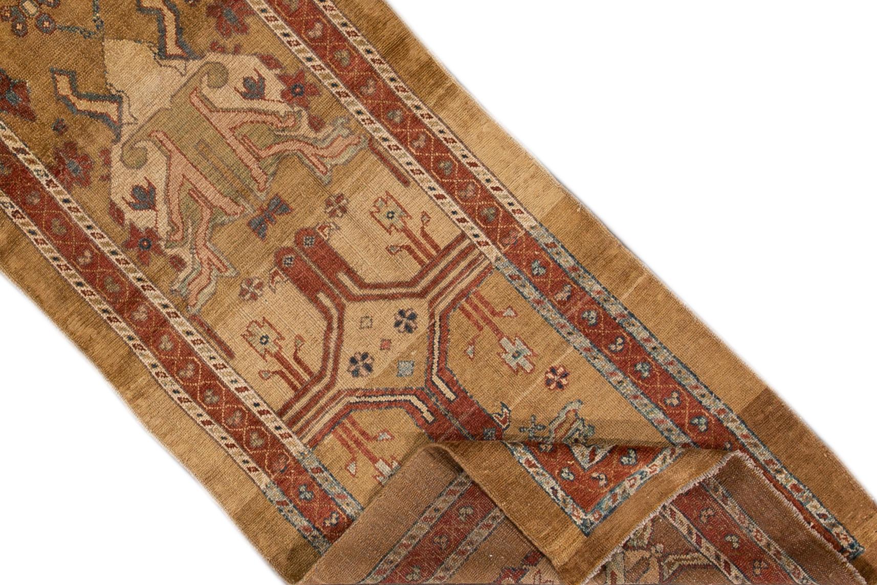 Beautiful vintage Bakshaish wool rug with a tan field, the fame of brown. This rug has multi-color accents in an all-over geometric design.

This rug measures 2' 9