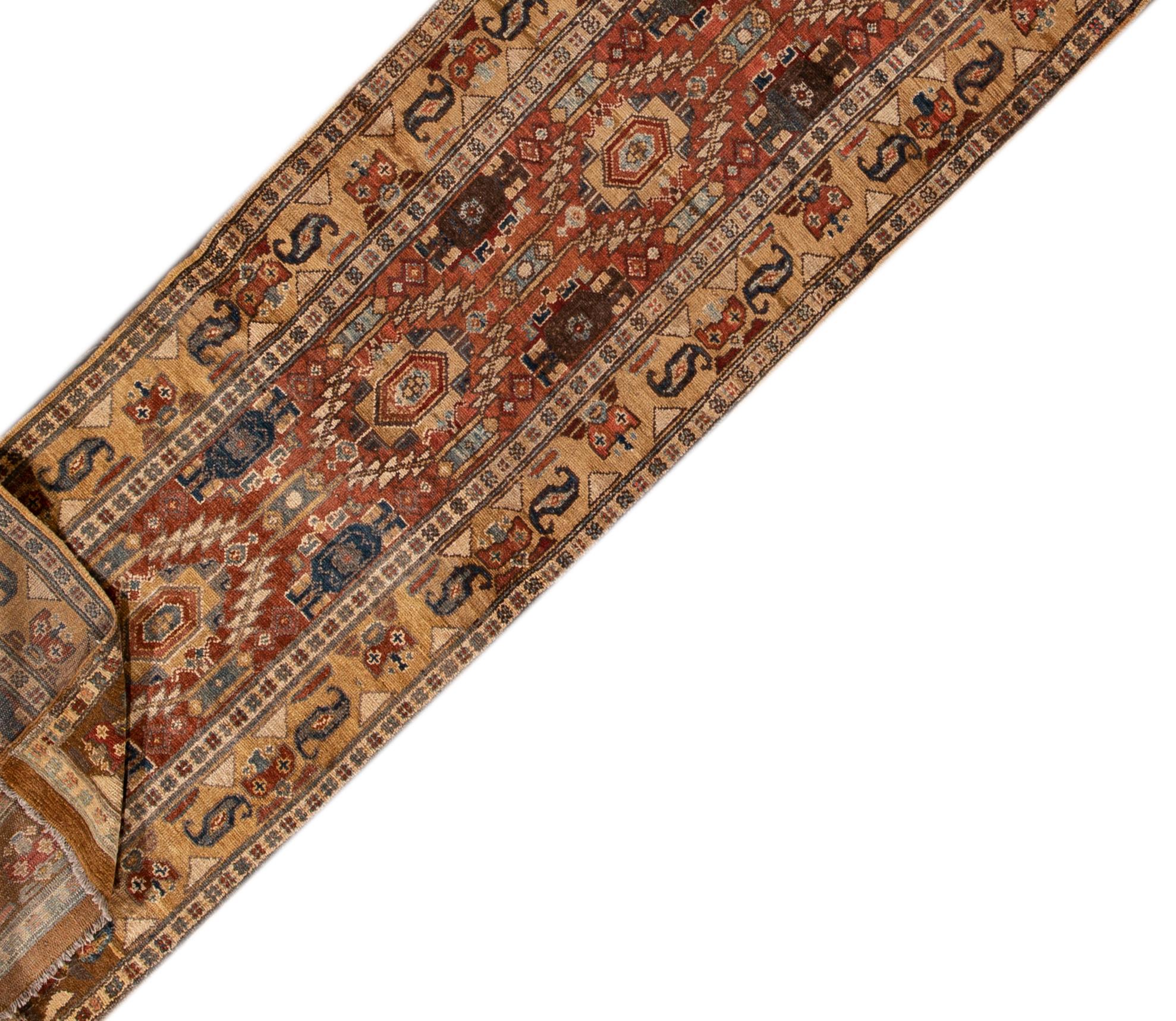 Beautiful vintage Bakshaish wool runner with a rust field, the fame of tan. This rug has multi-color accents in an all-over geometric design.

This rug measures 2' 9