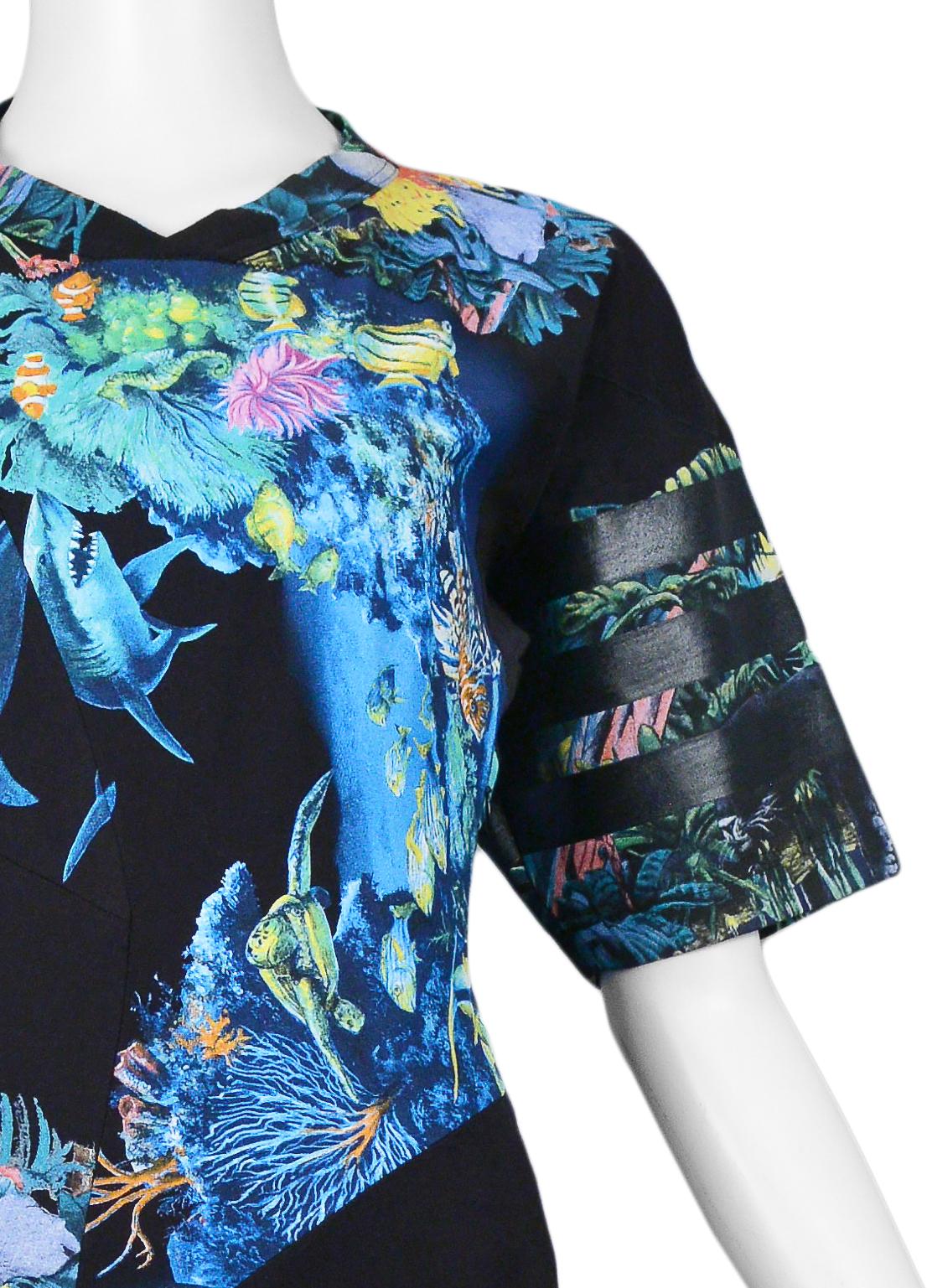 We are excited to offer a vintage Nicolas Ghesquière for Balenciaga iconic scuba dress featuring a printed montage of underwater and jungle motifs, elbow-length sleeves, plastisol stripes, and a v-neckline and front hemline.

Balenciaga