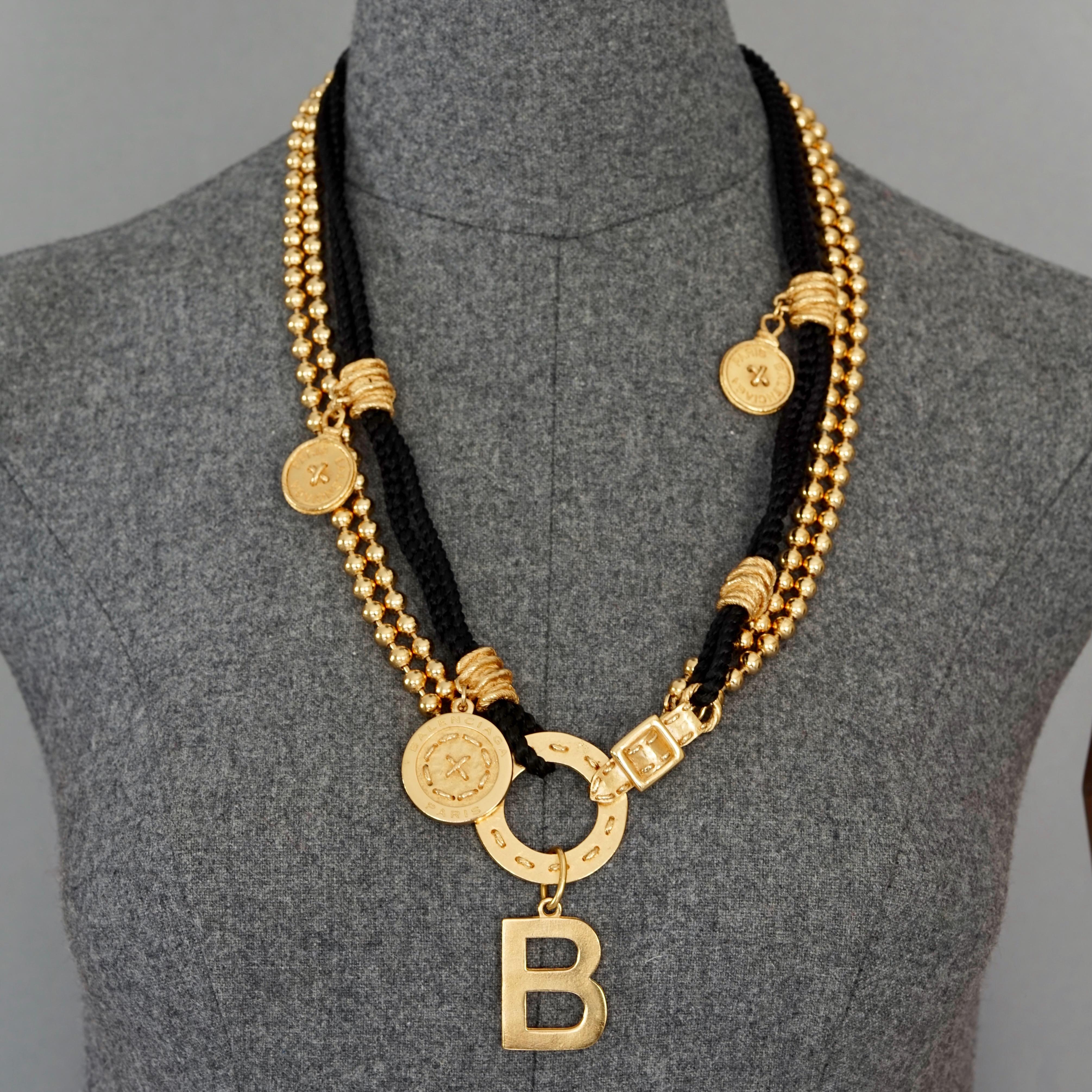 Vintage BALENCIAGA Art Deco Black Enamel Rhinestone Necklace

Measurements:
Discs: 2.95 inches (7.5 cm)
Wearable Length: 25.19 inches (64 cm)

Features:
- 100% Authentic BALENCIAGA.
- Multi Layer ball chains and black cords with charms.
- Hook