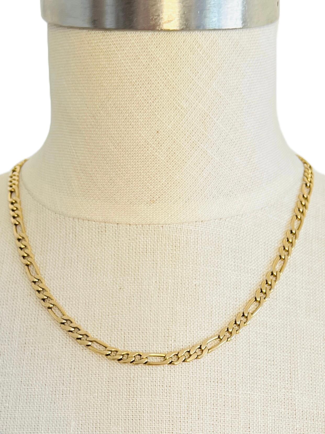 This vintage 14K gold Figaro chain necklace was crafted by the Italian jeweler Balestra. Weighing a solid 10.8 grams, this piece exemplifies superior craftsmanship, offering a durability and quality that distinguishes it from many modern chains,
