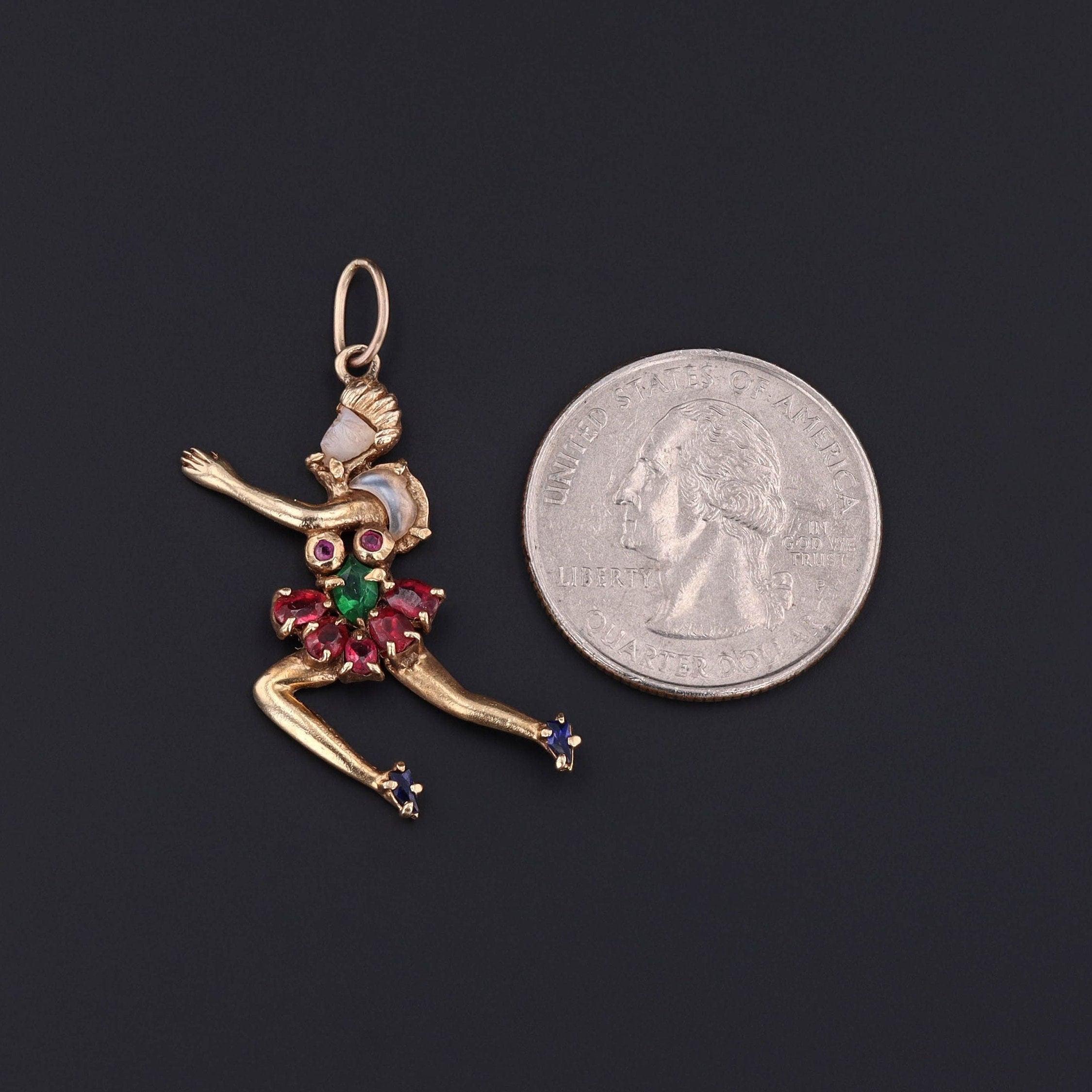 Vintage Dancer Pendant in 14k Gold with Carved Moonstone & Gem Doublets, circa 1940–1955

This whimsical yet refined vintage pendant (circa 1940–1955) captures the grace and charm of a mid-century dancer in motion, sculpted in warm 14k gold and