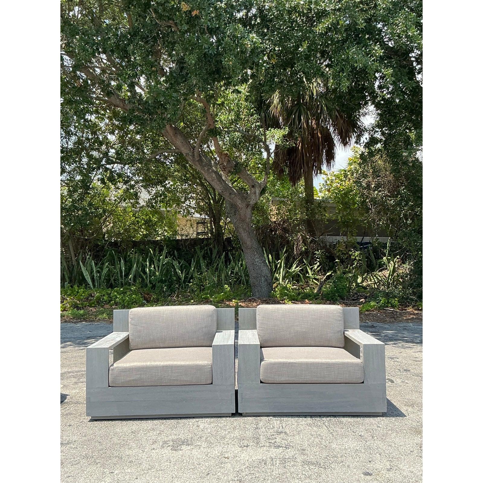 Elevate your outdoor or indoor living space with this stunning pair of “Balmain” lounge chairs After RH , crafted from solid teak wood in a sophisticated weathered grey wash. These designer chairs blend bold, architectural lines with a laid-back
