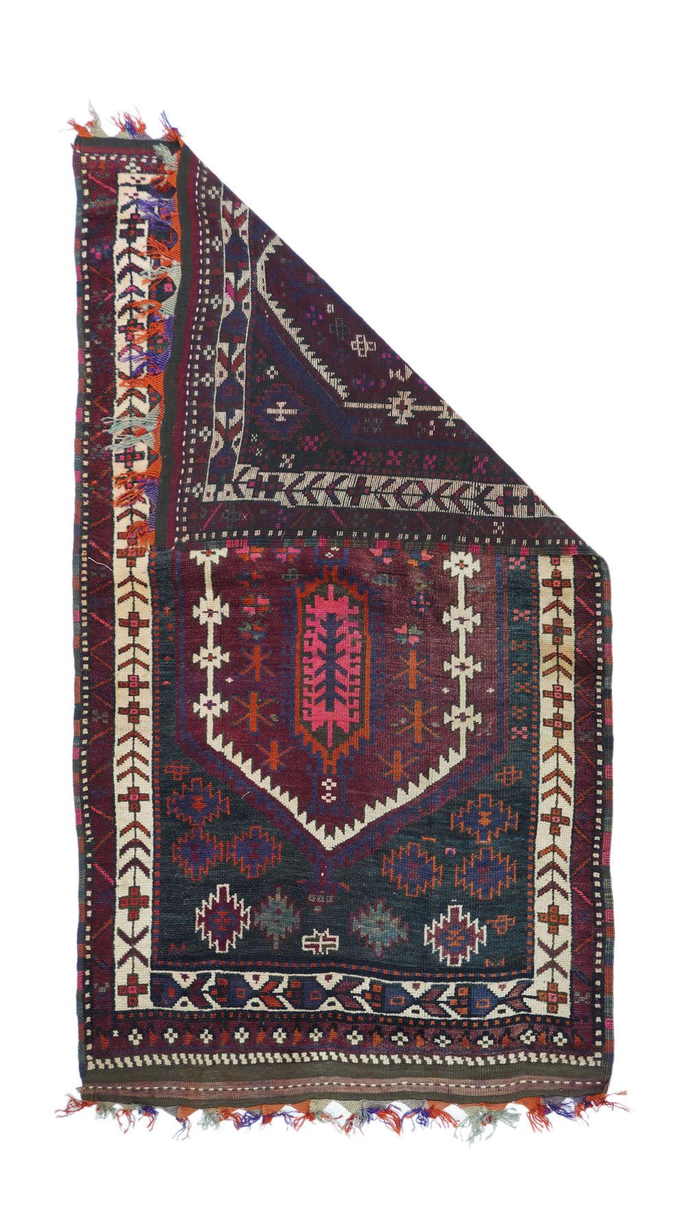 Vintage Balouch Rug 3'5'' x 6'2''. Ashiks anchor the ecru hexagonal wreath which encloses two elongated plaquettes, and minor stars and crosses. Larger ashiks run along one end of the wine-dark field. Ecru main border of chevrons, crosses and
