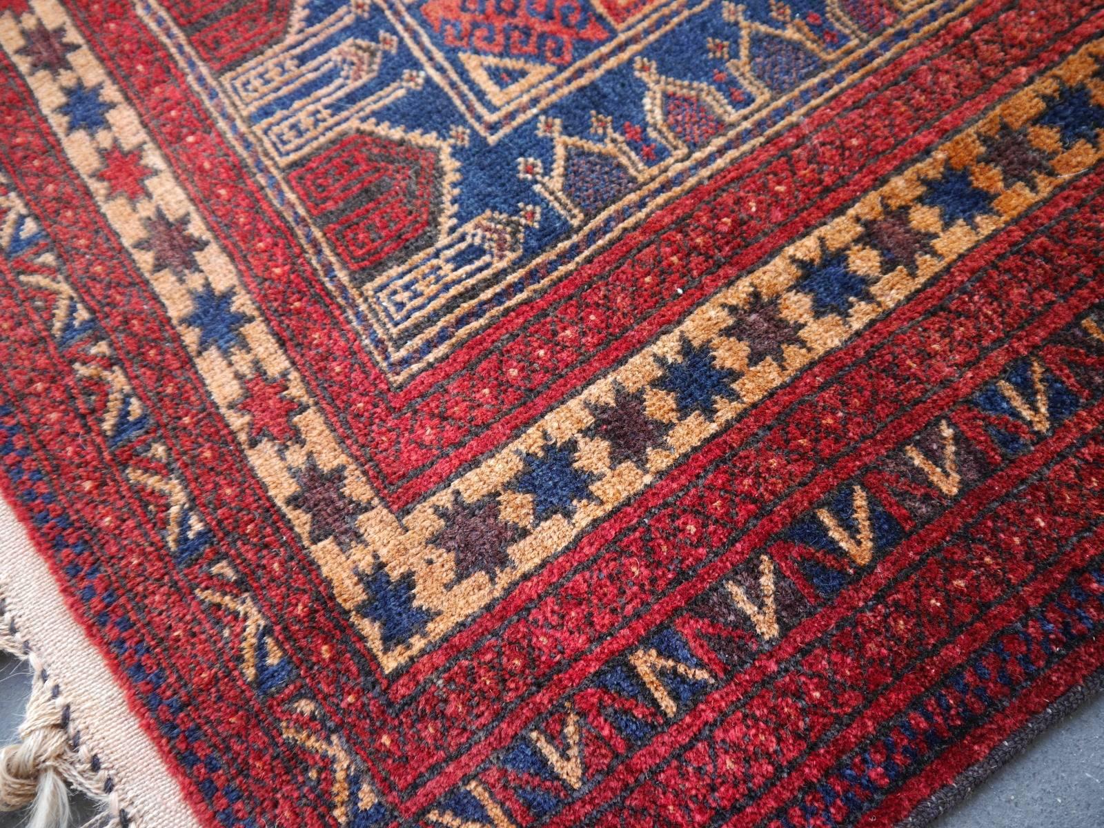 Vintage Balouch tribal prayer rug blue and rust color

• Beautiful vintage rug
• All handmade
• Pile pure wool
• Traditional design
• Condition: Very good, original fringes in excellent condition. One small old restoration, professionally