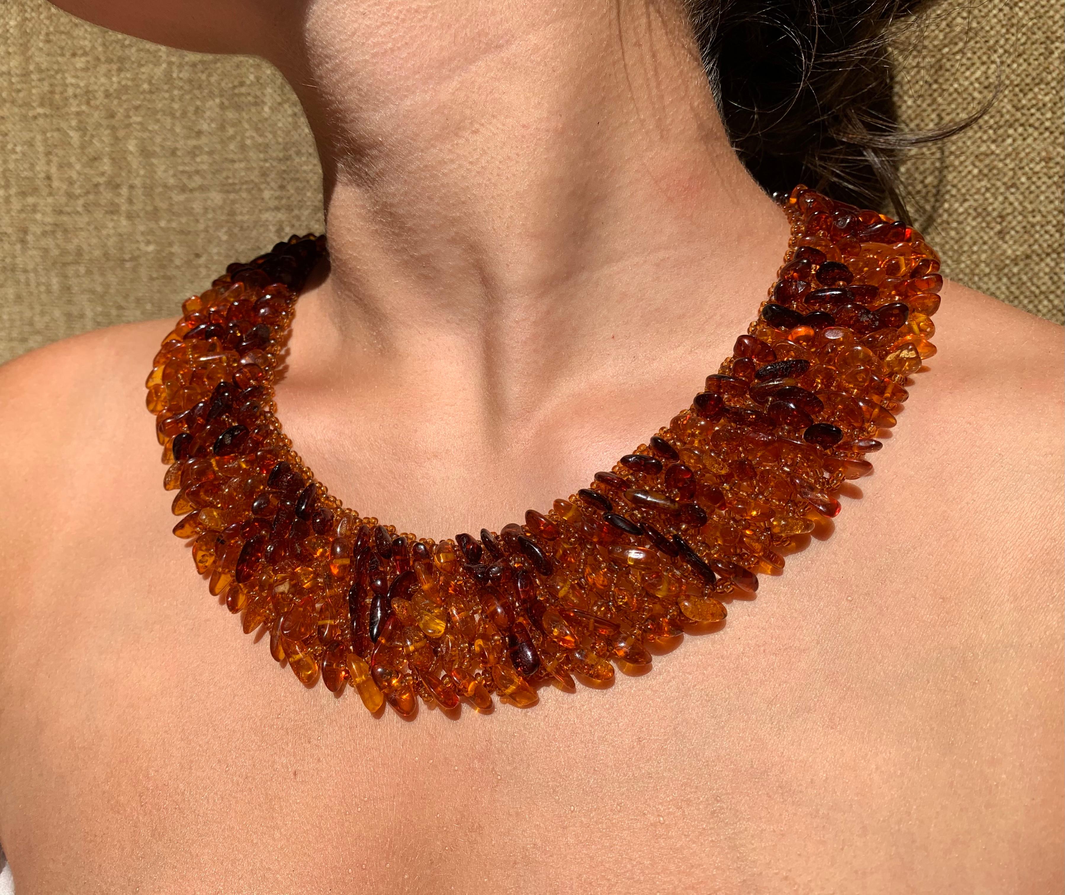 Striking wide Baltic amber necklace composed of natural tumbled amber artfully mounted on an amber colored glass bead setting, 14k gold filigree clasp.
Hand made, fabulous scale - 1.5 
