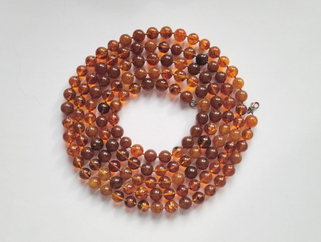 The length of the necklace is 72 inches (183 cm). Beautiful beads from rare genuine Baltic amber. The size of the smooth round amber beads is 12mm.
The beads are semi-transparent. The color of amber is color is rich, varying from honey, cognac,