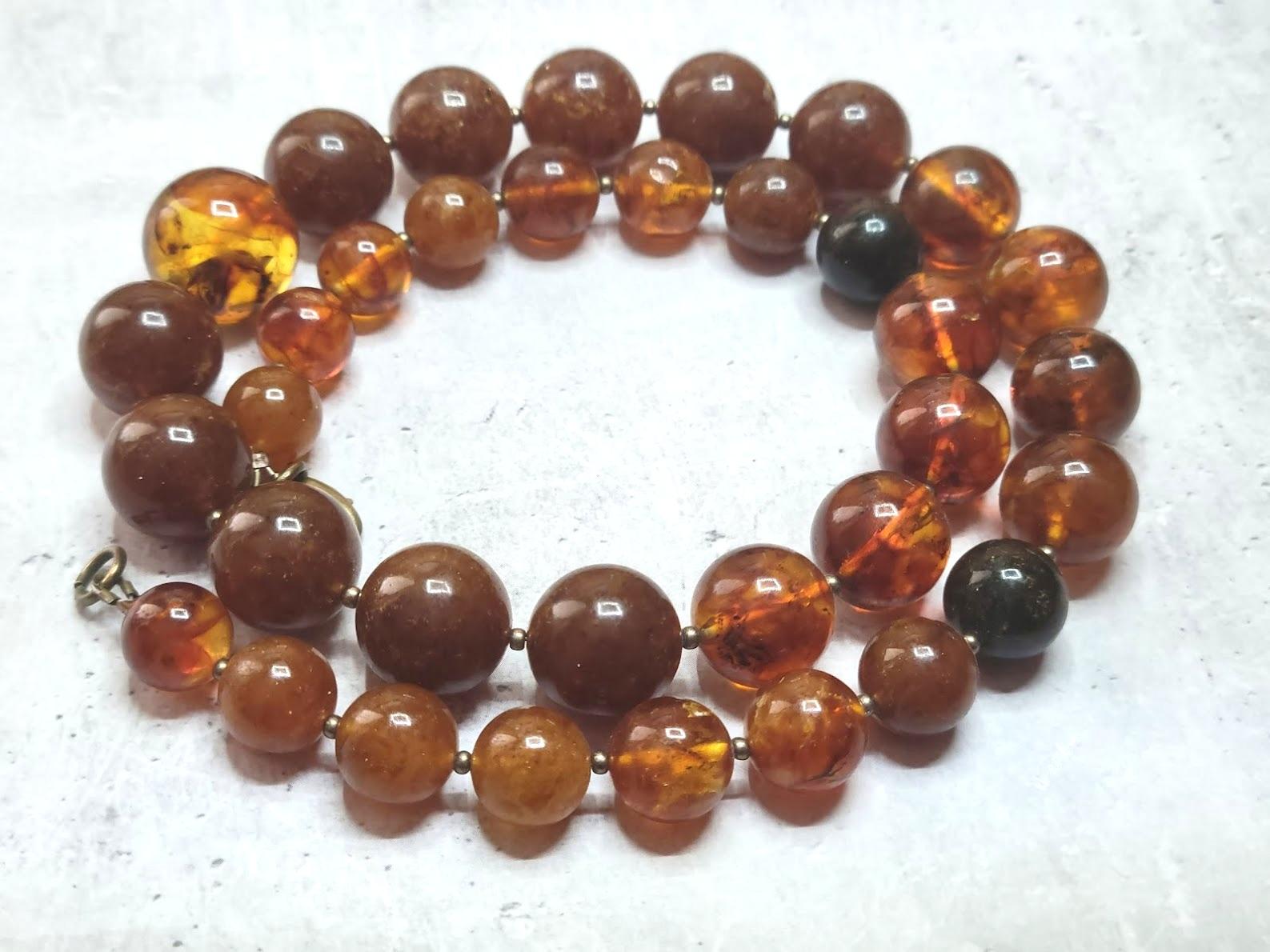 The length of the necklace is 21.5 inches (54.6 cm). Beautiful beads from rare genuine Baltic amber. The smooth round amber beads vary from 11 to 17.5mm.
Several beads are semi-transparent. The color of amber is color is rich, varying from honey,