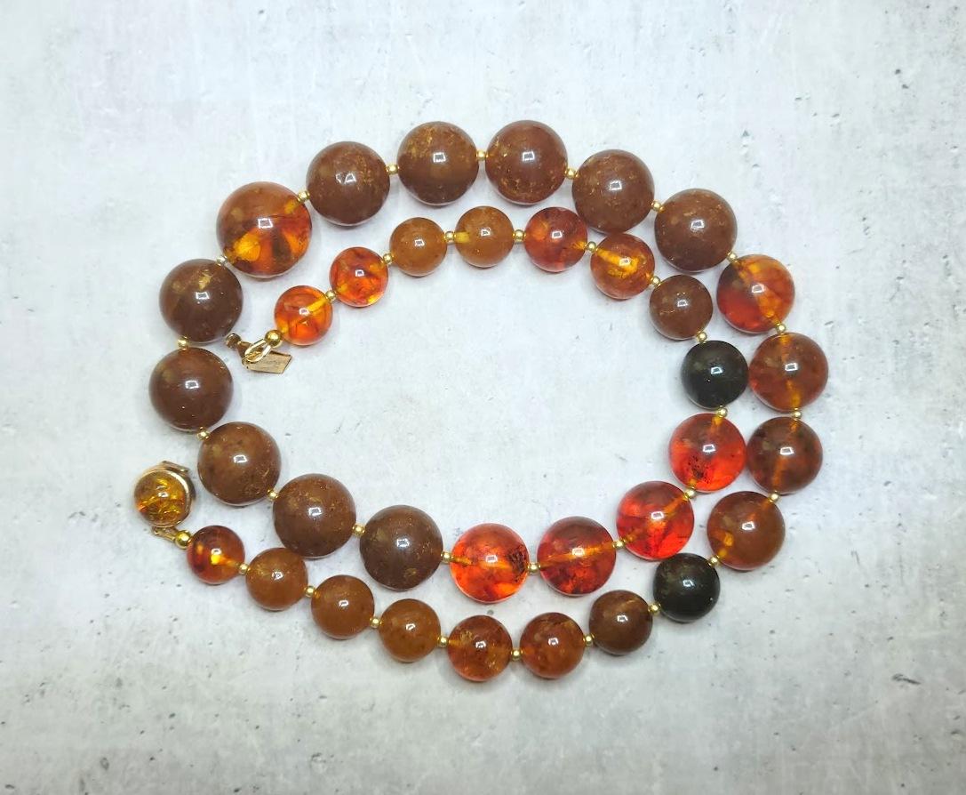The length of the necklace is 21.5 inches (54.6 cm). Beautiful beads from natural Baltic amber. The smooth round amber beads vary from 11 to 17.5mm.
Several beads are semi-transparent. The color of amber is color is rich, varying from honey, cognac,