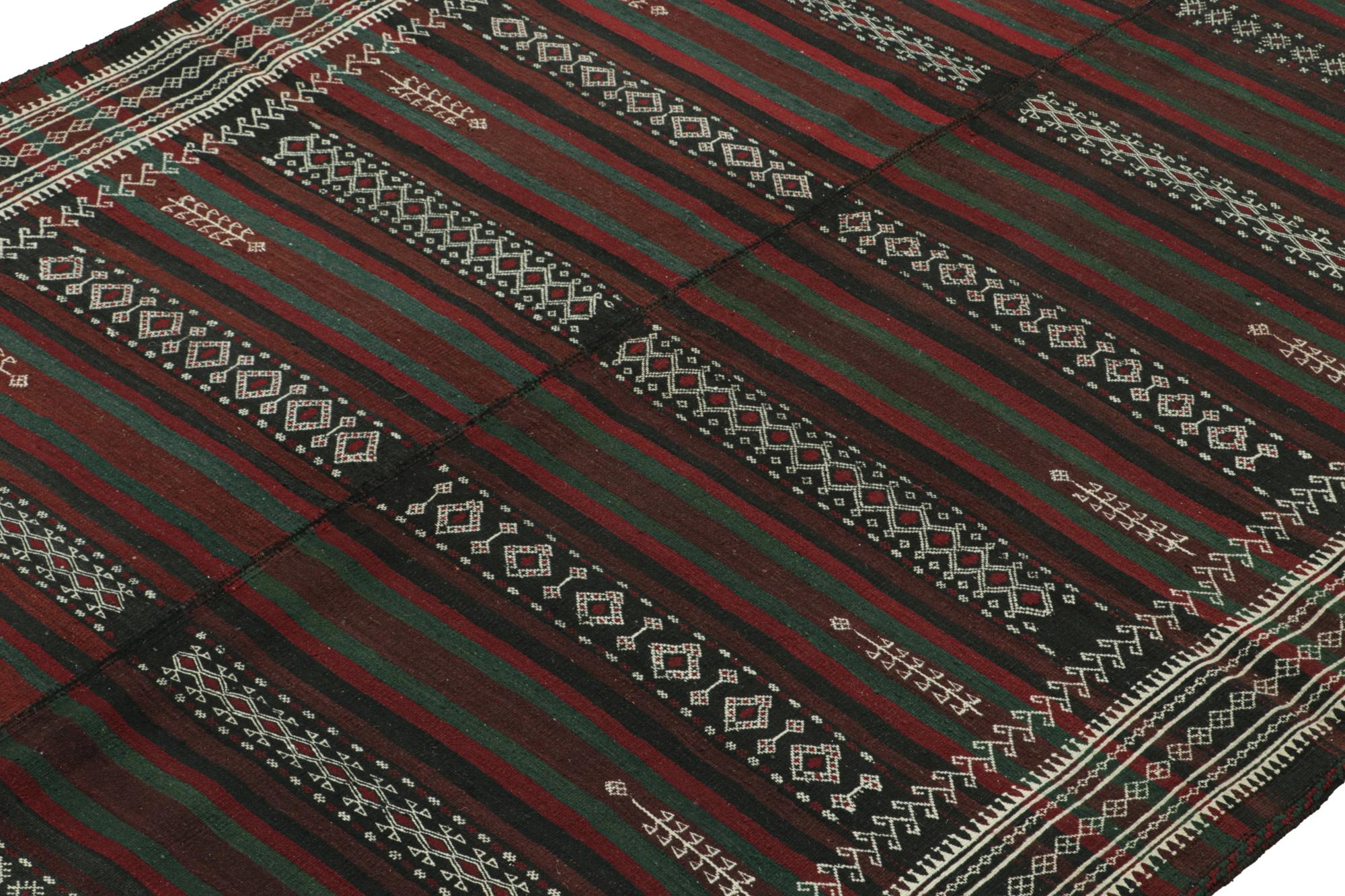 Hand-knotted in wool circa 1950, this 6x10 vintage Persian Kilim is a tribal rug of Baluch provenance.

On the Design: 

This flatweave enjoys stripes and sharp, finely woven geometric patterns in a rich palette of deep brown with red, teal and