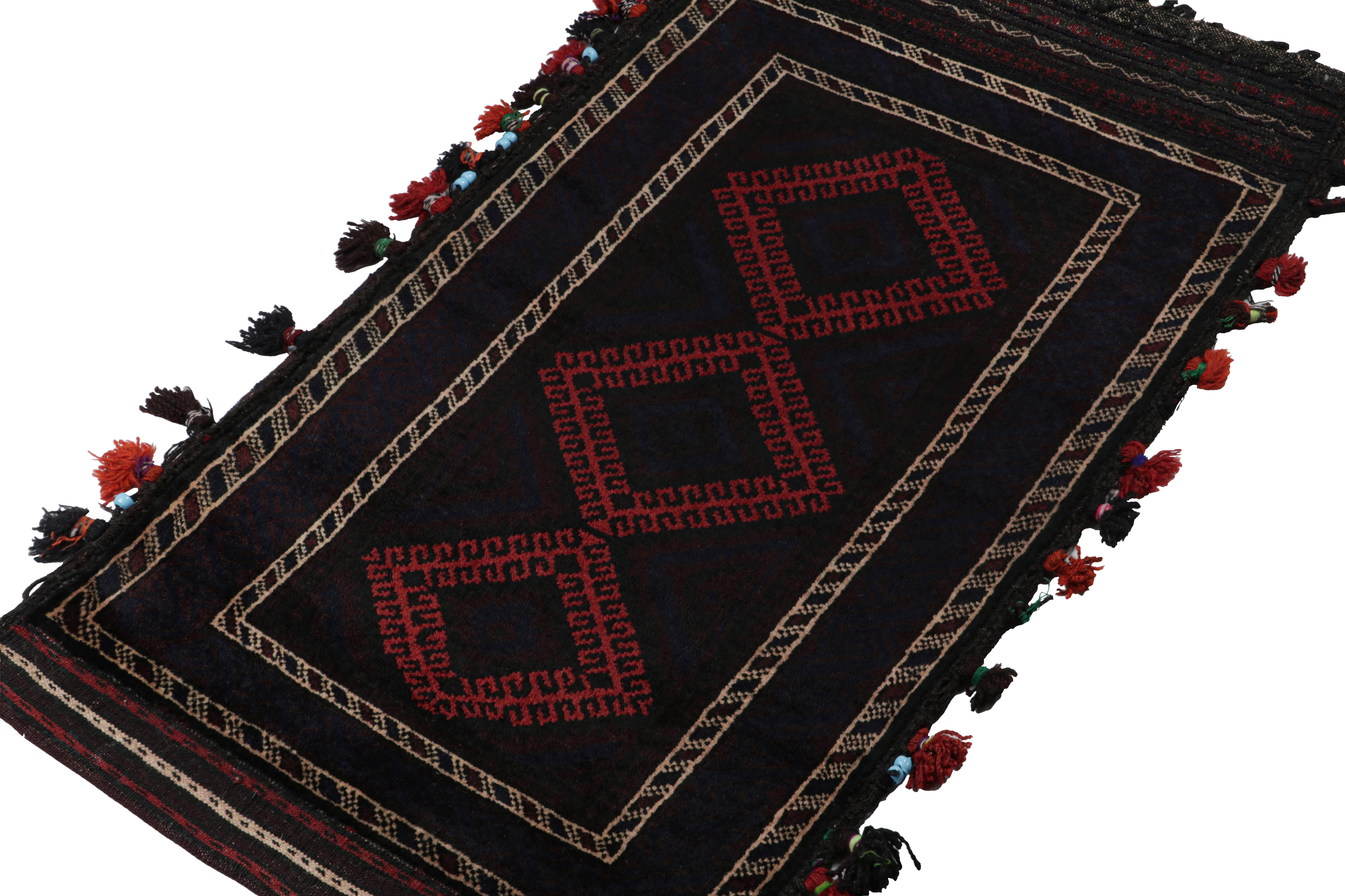 Hand-knotted in wool, this 2x3 Baluch Persian rug of the 1950s is the latest to enter Rug & Kilim’s Antique & Vintage collection.

On the Design:

The piece carries tribal geometric patterns in rich tones of red & black. A keen eye will note hints