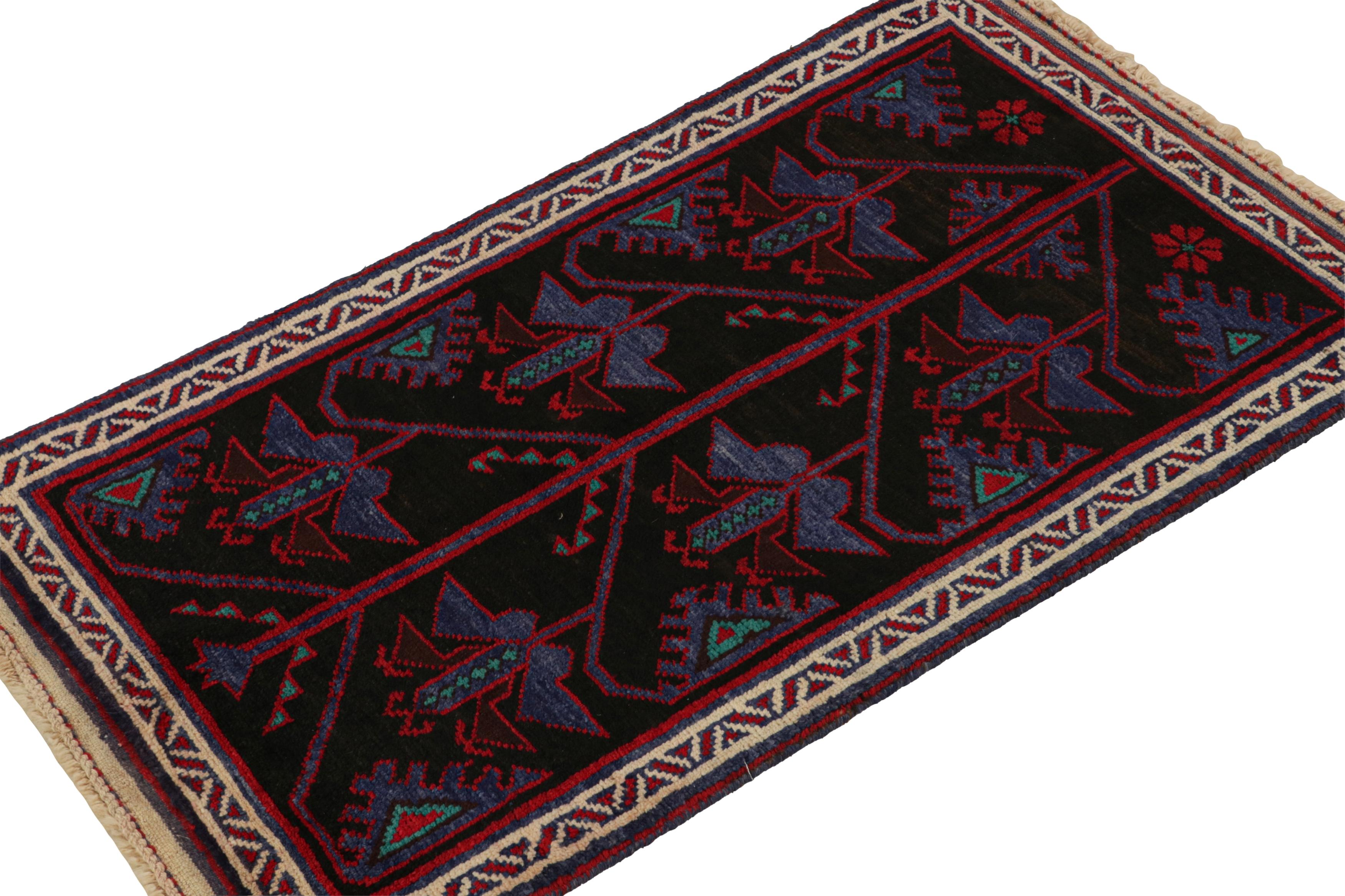 Hand-knotted in wool, this 3x5 Baluch Persian rug of the 1950s is the latest to enter Rug & Kilim’s Antique & Vintage collection.

On the Design:

The Persian Baluch rug carries patterns in rich tones of red & blue on black. The field is encased in