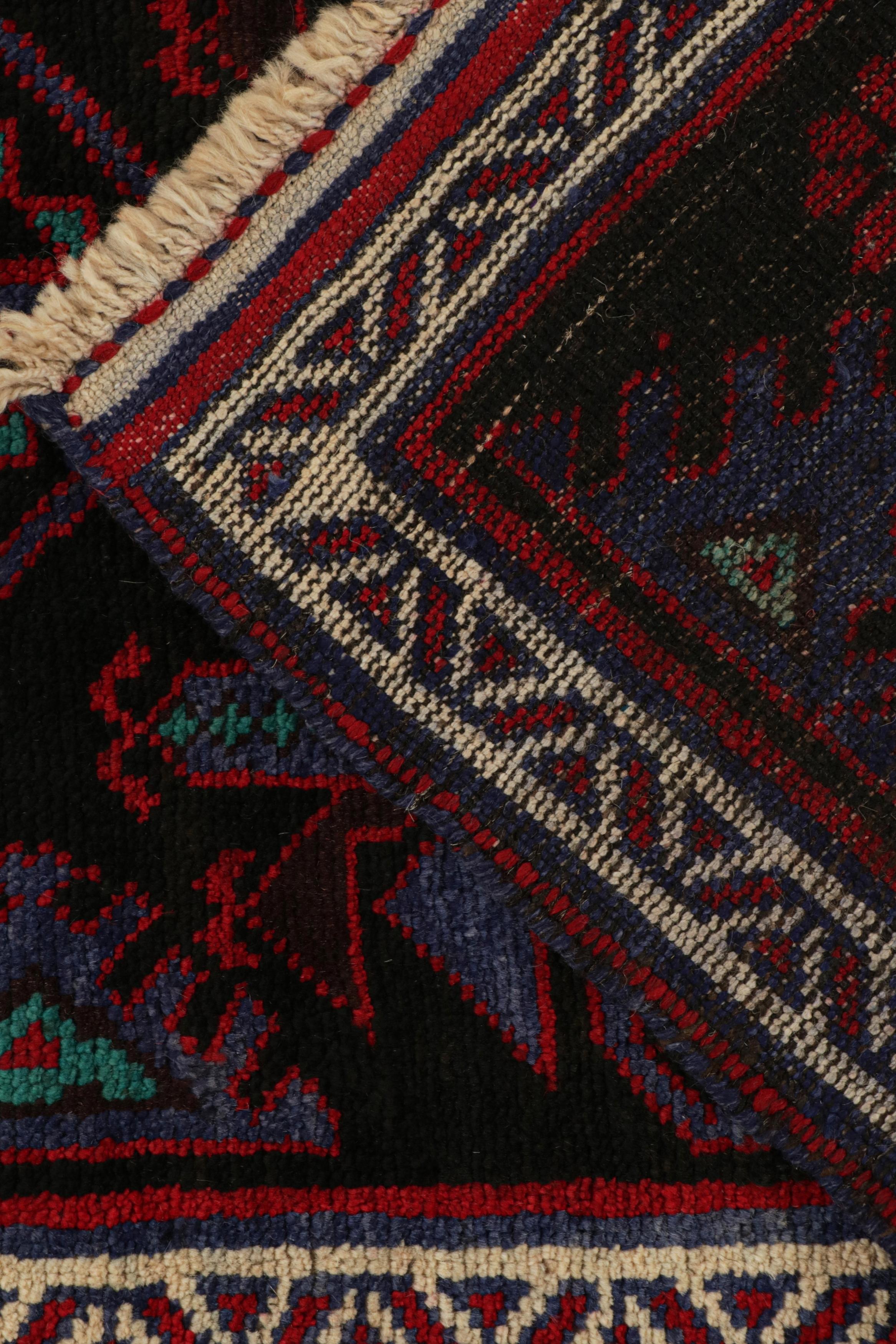 Wool Vintage Baluch Persian rug in Black with Red & Blue Patterns from Rug & Kilim For Sale
