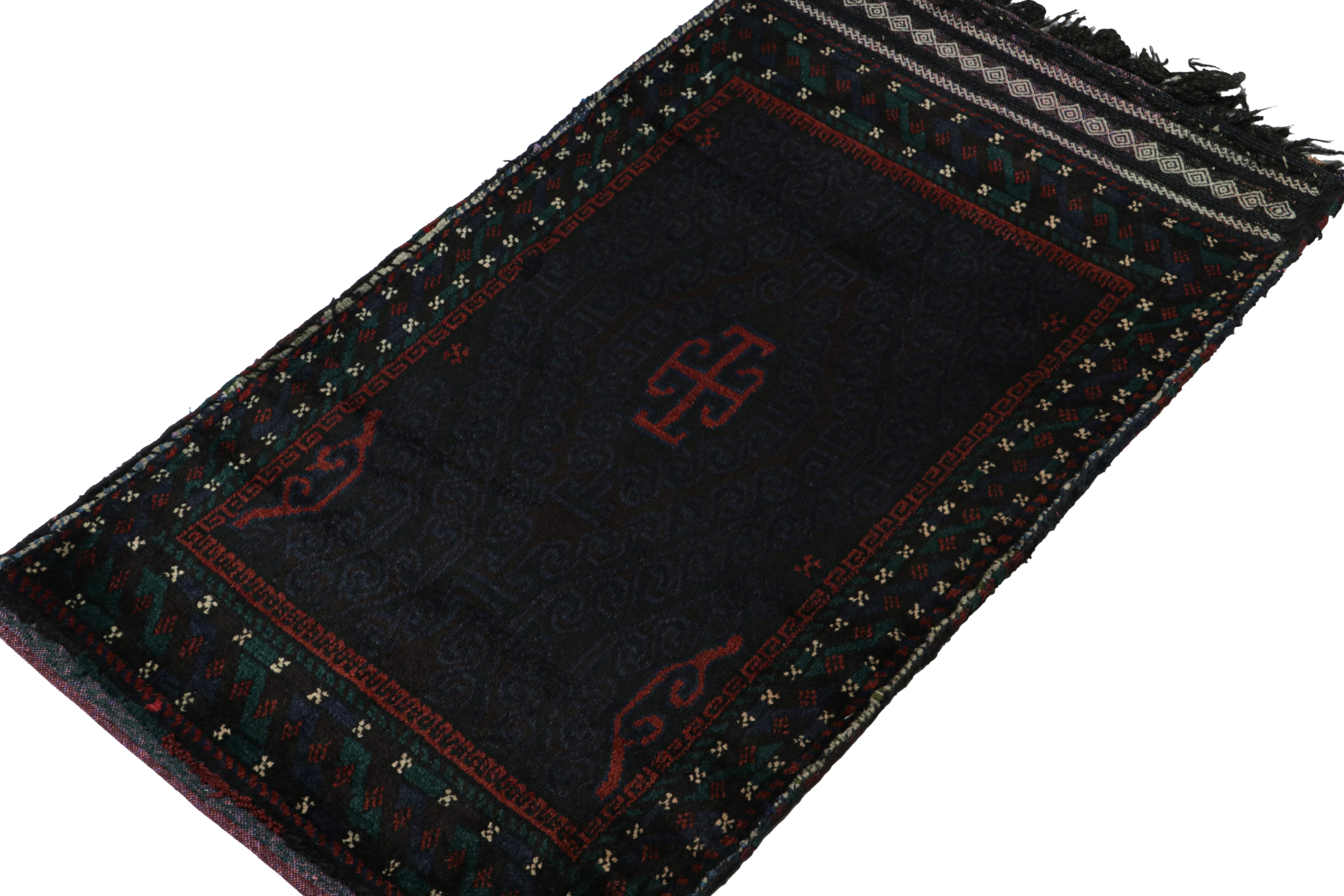 Hand-knotted in wool, this 2x4 Baluch Afghan rug of the 1950s is the latest to enter Rug & Kilim’s Antique & Vintage collection.

On the Design:

The vintage Baluch rug carries tribal geometric patterns in rich tones of red & black on a dark blue