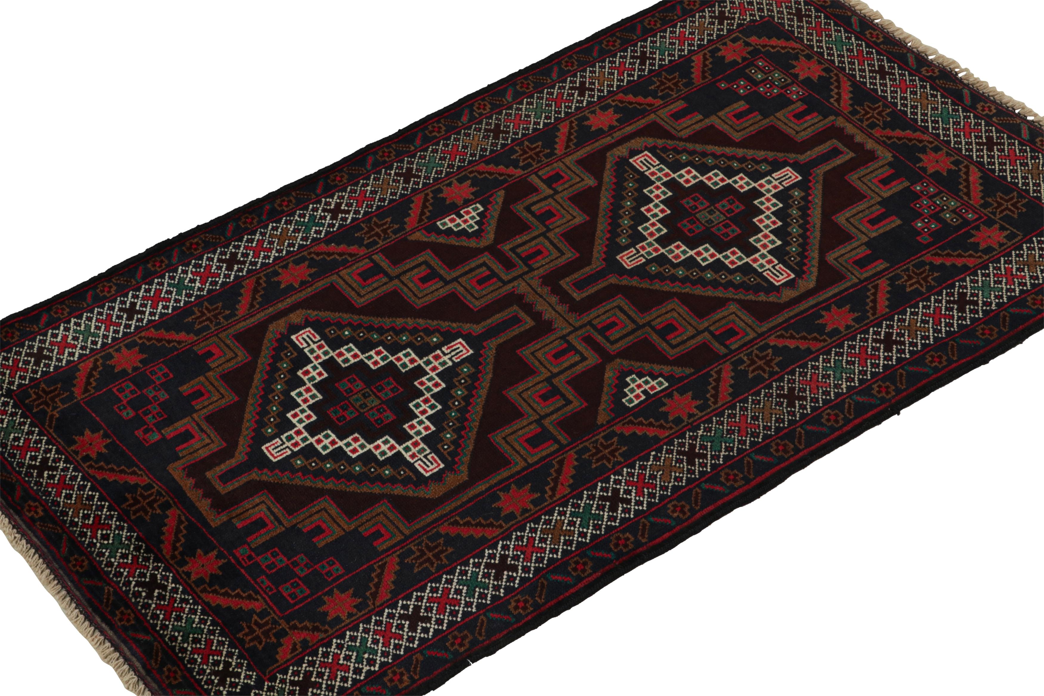 Hand-knotted in wool circa 1950-1960, this 3x5 vintage Baluch Persian rug is a new curation from the Rug & Kilim collection. 

On the Design: 

This tribal runner enjoys medallions and geometric patterns in rich red, midnight blue and brown tones.