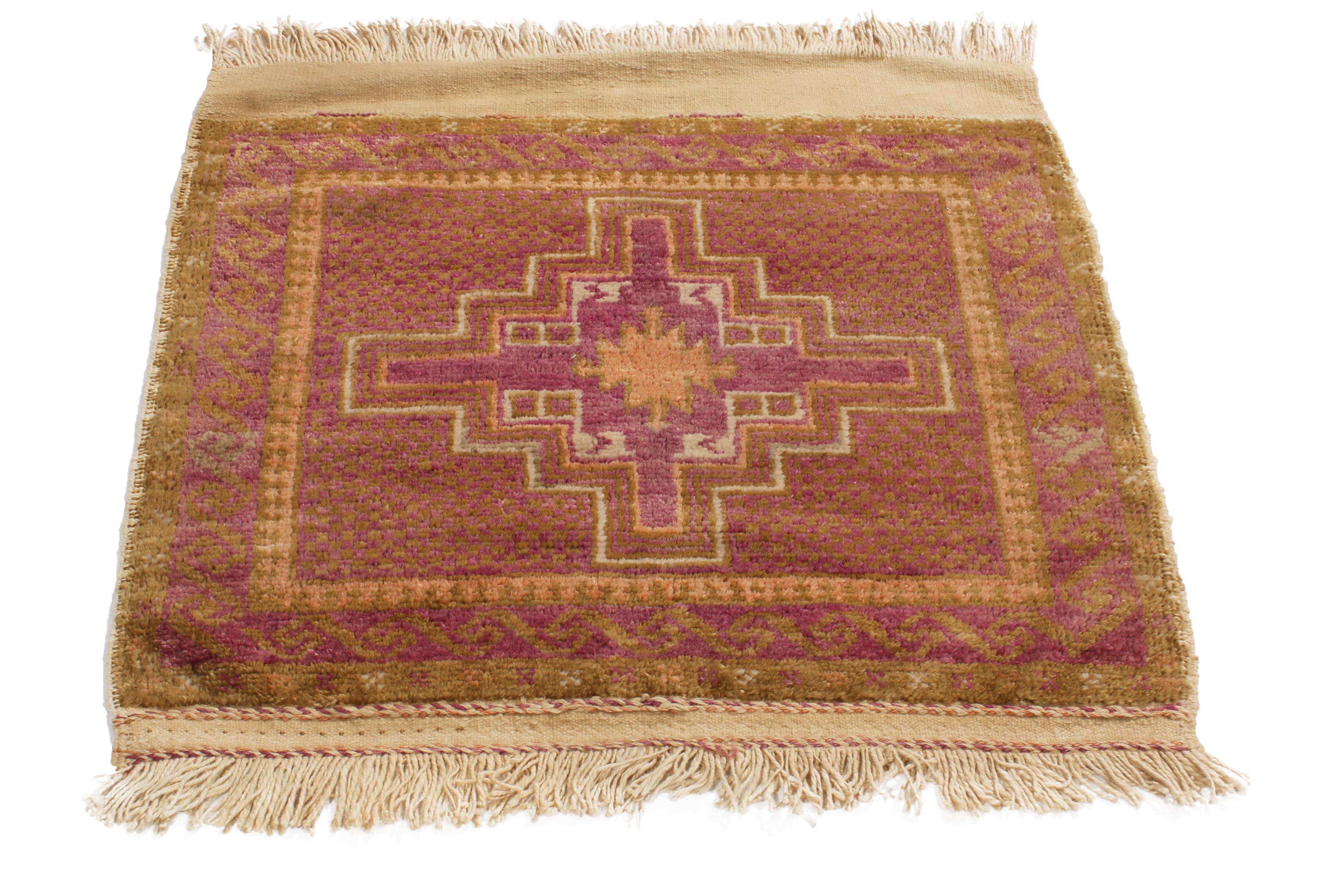 Hand knotted in a durable, high-quality wool body originating from Persia in 1950, this vintage Baluch Persian square rug hosts one of the most uncommon combinations of luminous purple and gold colorways in its borders and field design, sharing a