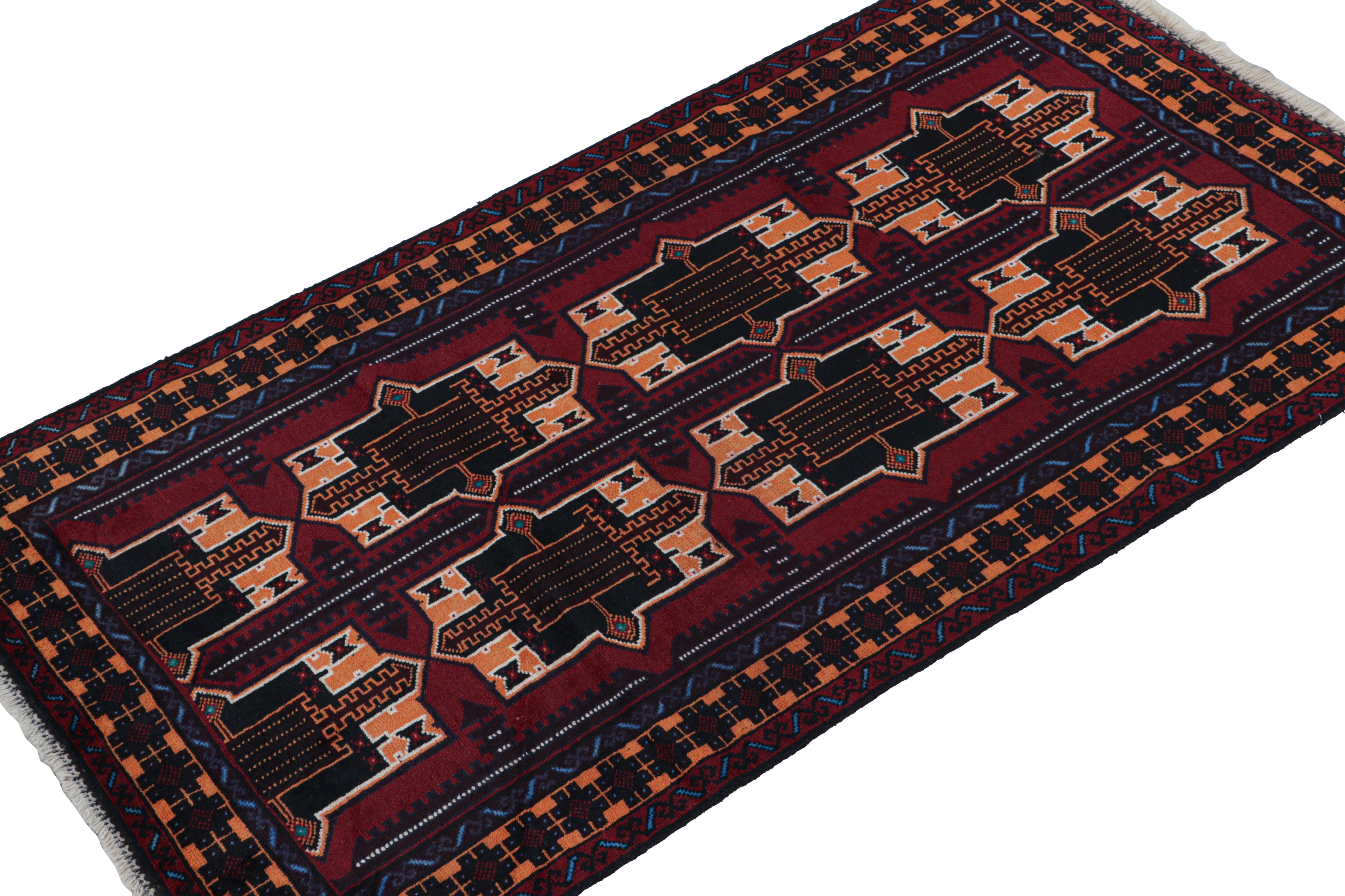Hand-knotted in wool & goat hair circa 1950-1960, this 3x6 vintage Baluch runner rug is an exciting new tribal curation from Rug & Kilim. 

On the Design: 

This piece enjoys an unusual, bright orange accent among the more traditional burgundy, navy