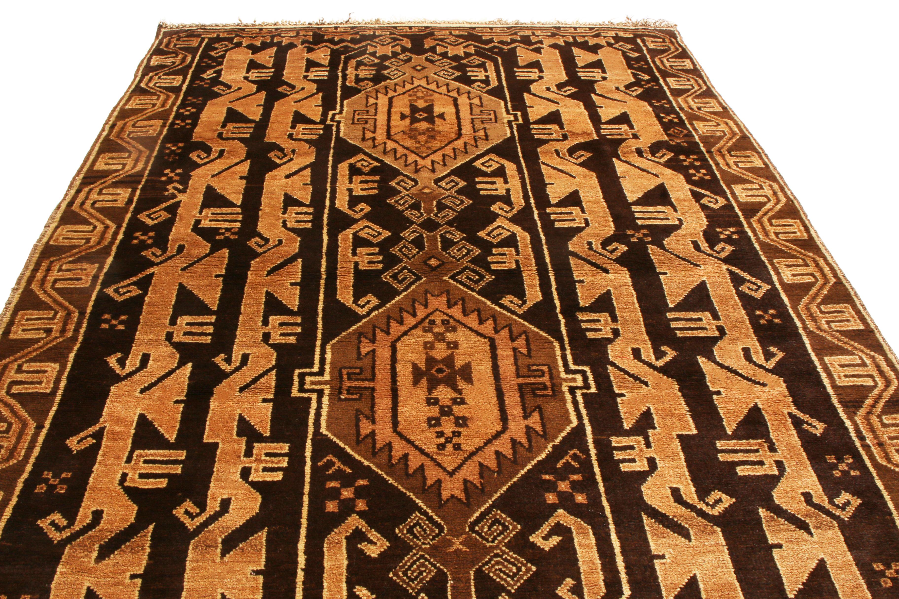 Originating from Persia in 1960, this vintage transitional Baluck wool Persian rug features a distinctly rich variation of color and uncommon pattern. Hand knotted in high quality, luminous wool, the medallions and dancing columns in the field and