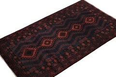 Rug & Kilim’s Baluch Rug in Dark Blue with Brick Red Geometric Patterns