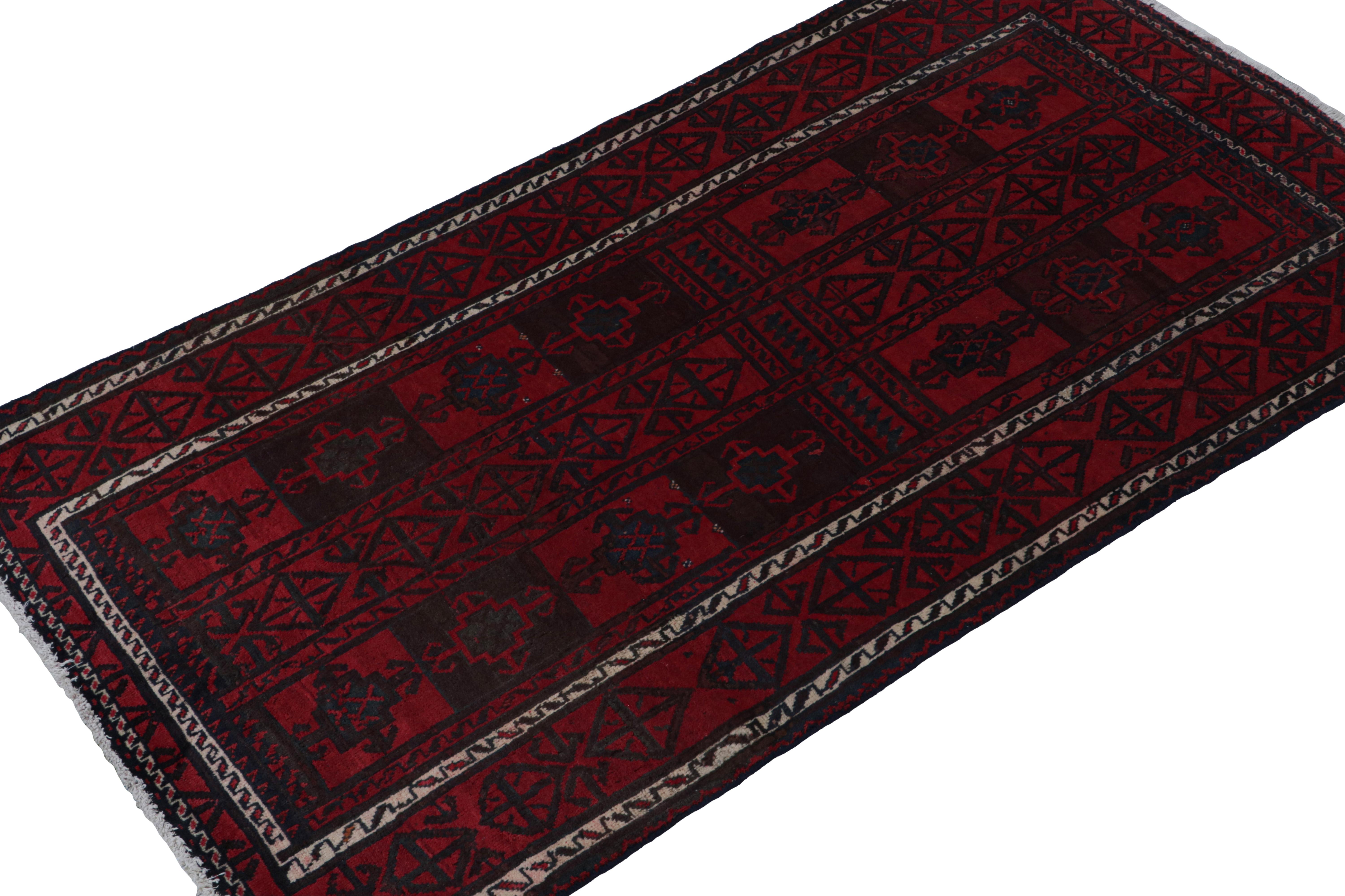 Hand-knotted in wool & goat hair circa 1950-1960, this 4x7 vintage Baluch rug is a new curation from Rug & Kilim. 

On the Design: 

Named for the same nomadic weavers, this tribal rug enjoys sharply drawn geometric patterns in rich red and navy