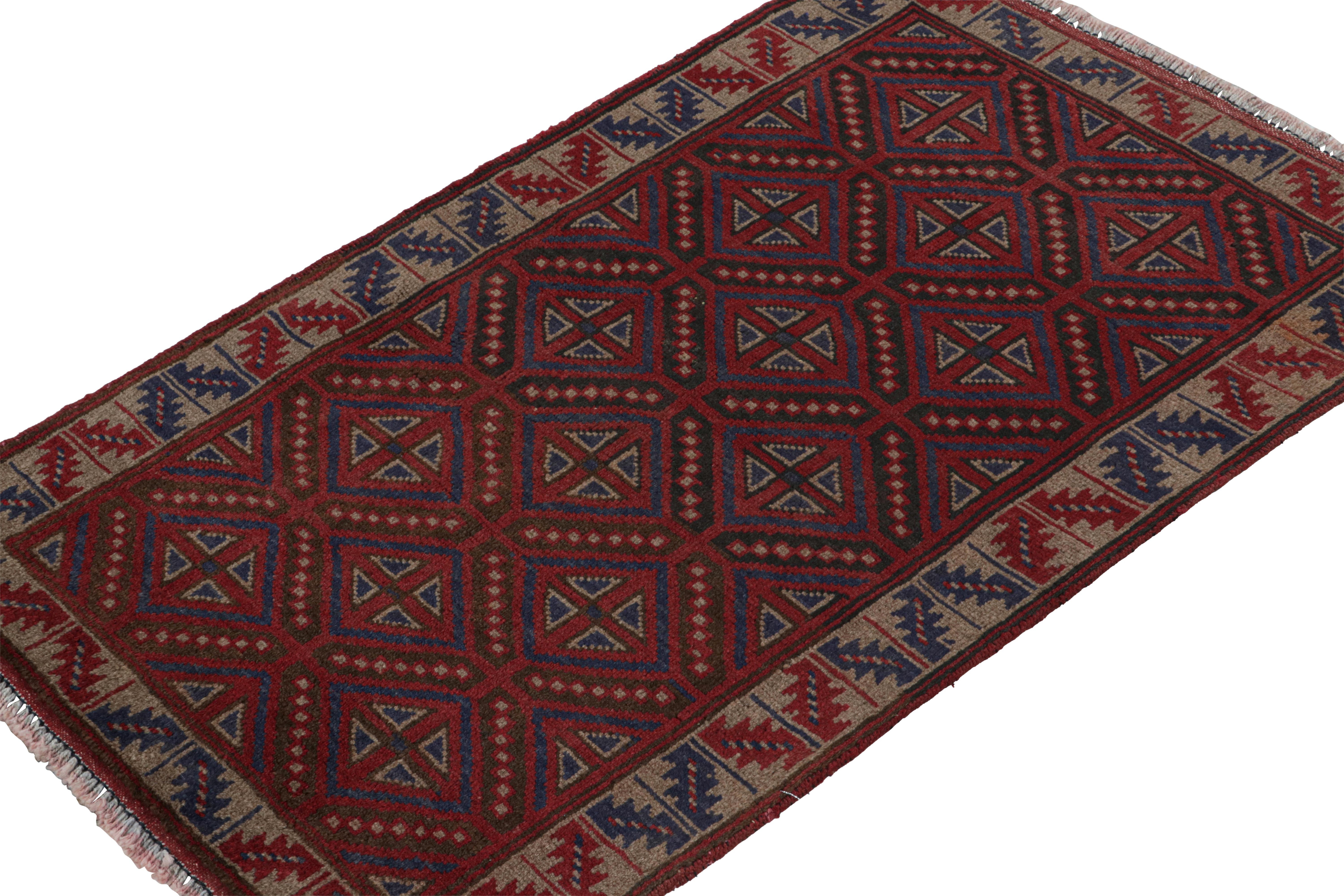 Hand-knotted in wool and goat hair circa 1950-1960, this vintage Baluch tribal rug is a new curation from the Rug & Kilim collection.  

On the Design:

This piece enjoys geometric patterns in rich tones of red and navy blue, and a beige border.