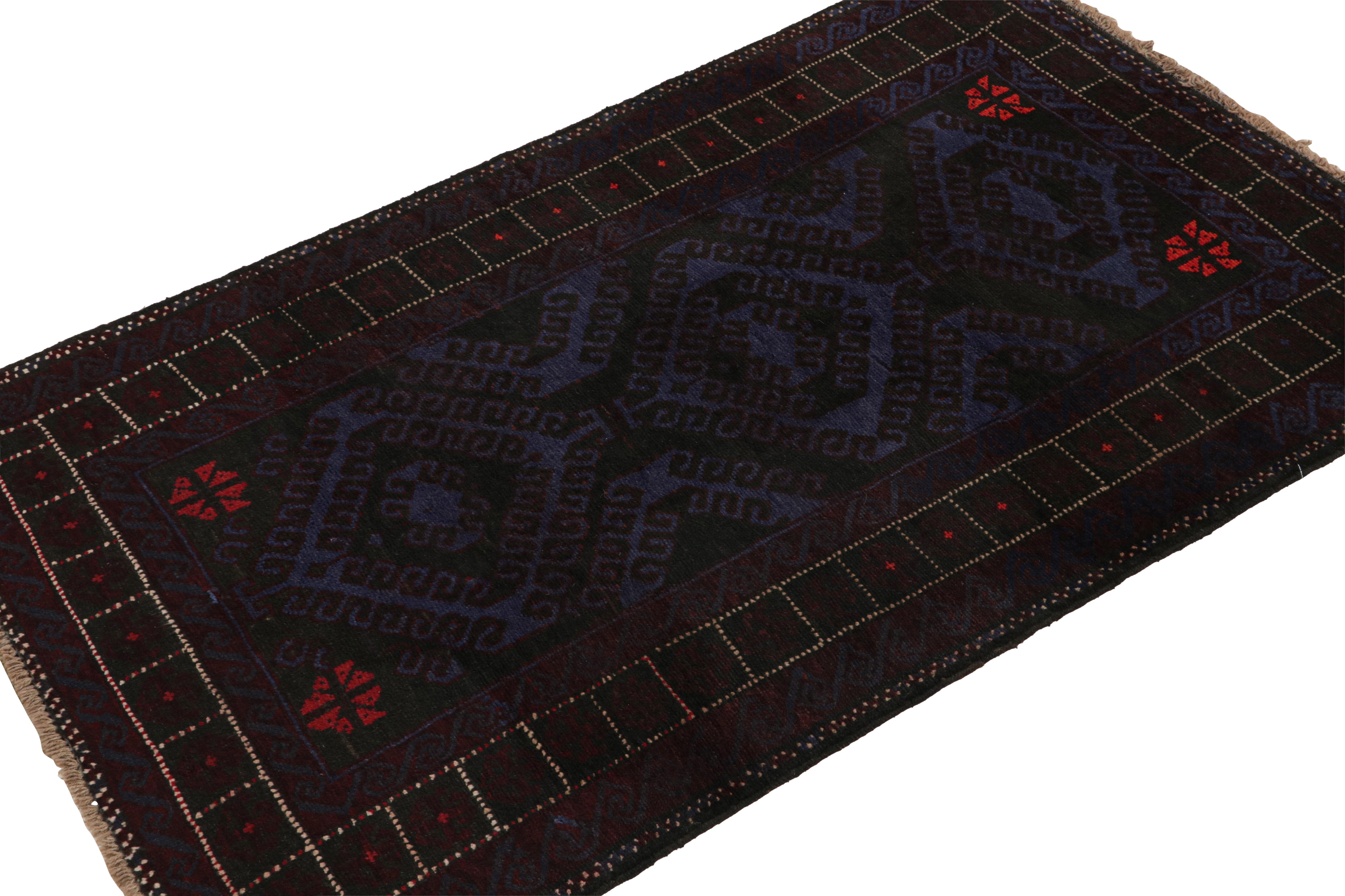 Hand-knotted in wool and goat hair circa 1950-1960, this 4x6 vintage Baluch tribal rug is a new curation from Rug & Kilim. 

On the Design: 

This runner rug enjoys navy blue and indigo undertones, with black geometric patterns and bordeaux accents.