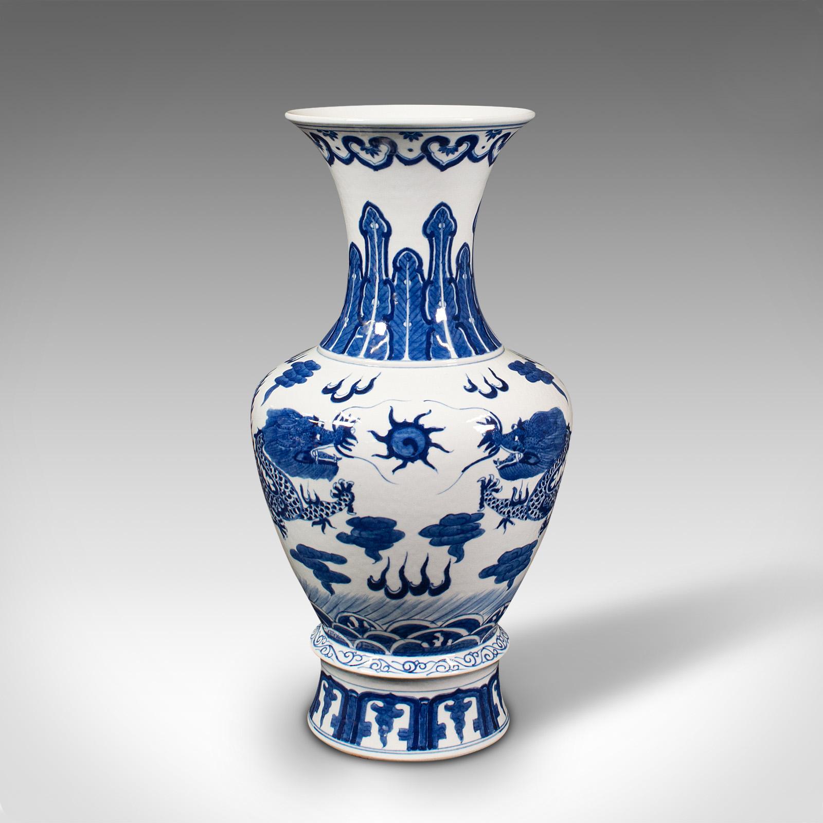 This is a vintage baluster vase. A Chinese, ceramic decorative display vase, dating to the late Art Deco period, circa 1940.

Presents the iconic white and blue finish with Oriental taste
Displays a desirable aged patina, free of marks or