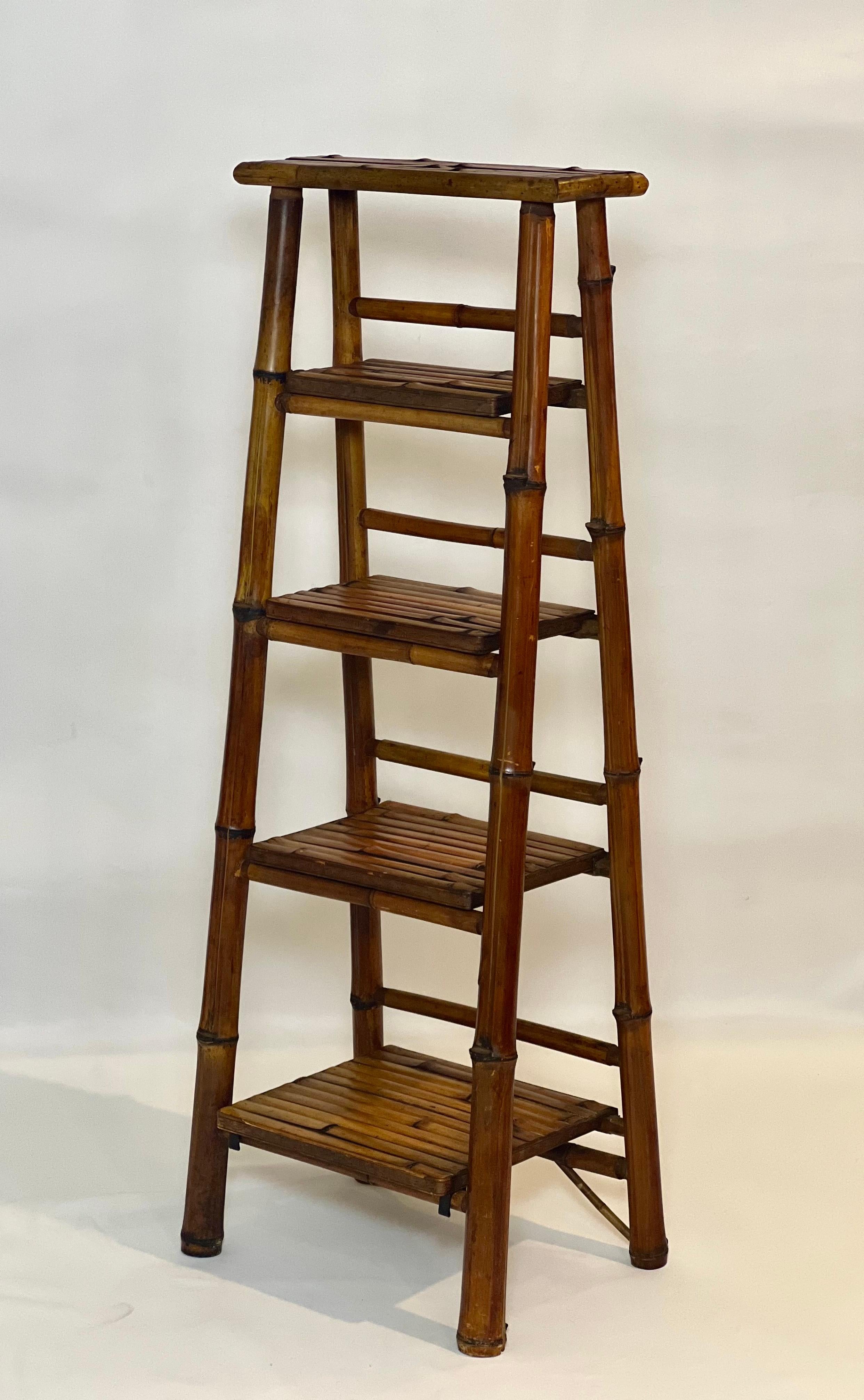 Vintage bamboo A-frame etagere or book stand, c. 1950s.

Slim and airy bamboo stand with five graduated tiers great for displaying plants, books, linens and photos. Its slender form allows it to fit in many spaces while adding nice height and