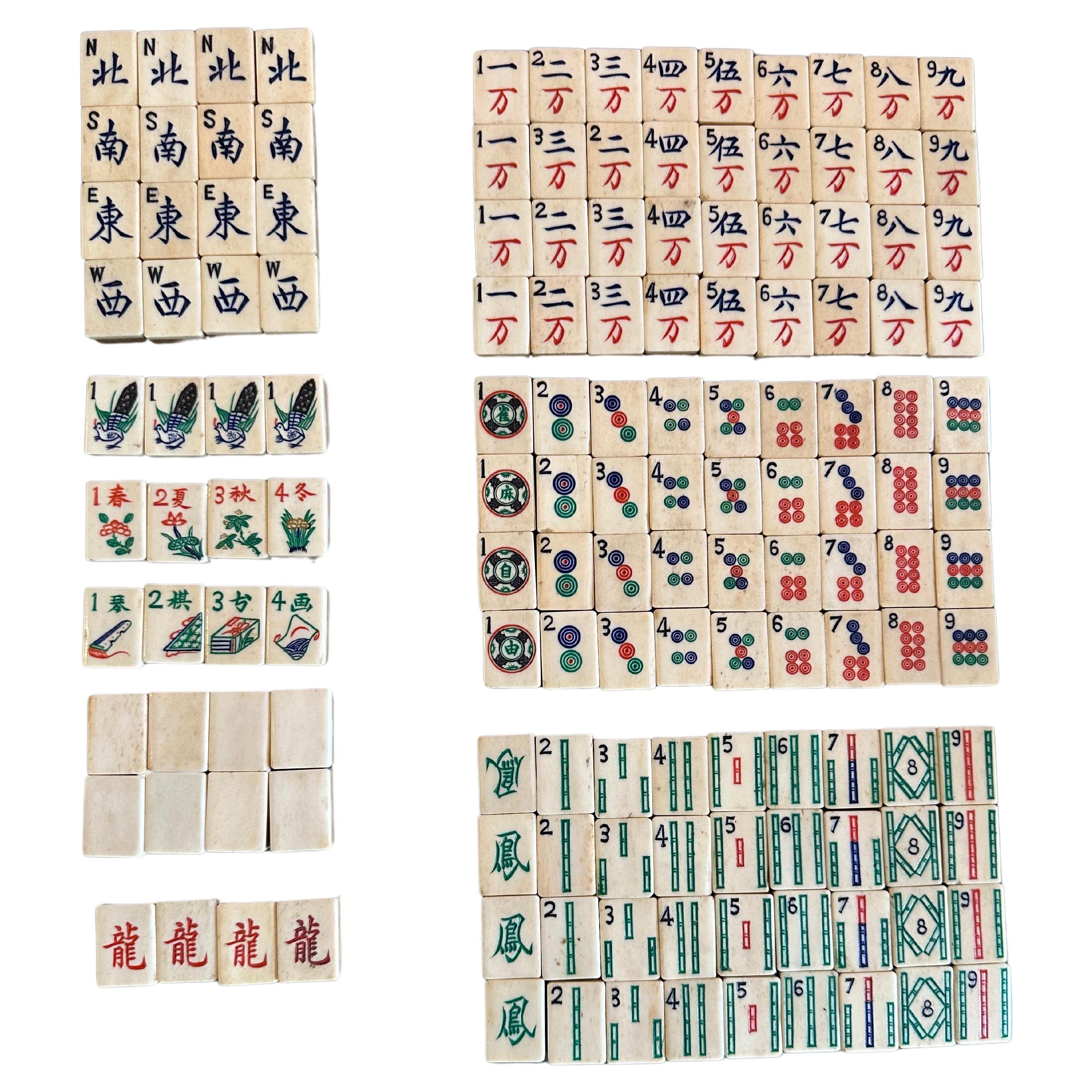 Vintage bamboo and bone Chinese mahjong set with betting sticks in wood box, circa 1960s.  Beautiful, high quality set of 148 dovetail bone and bamboo tiles, betting sticks and solid wood storage box.  The set is in very good vintage condition and