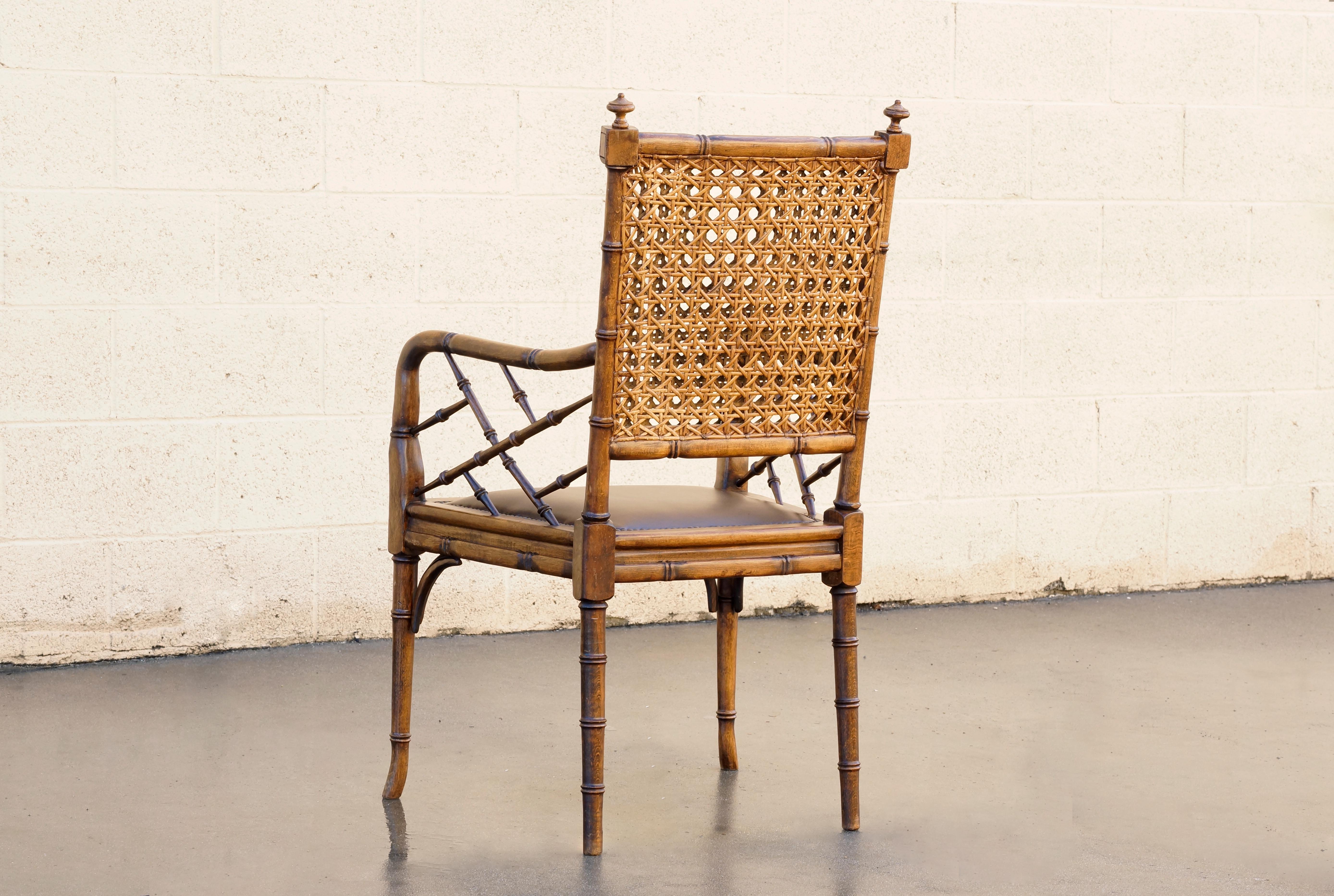 Elegant side chair with featuring bamboo style wood frame, double walled cane back and newly upholstered leather seat with upholstery tacks. Design is reminiscent of the Aesthetics Movement popular in Britain the late 1800s which emphasized a Far