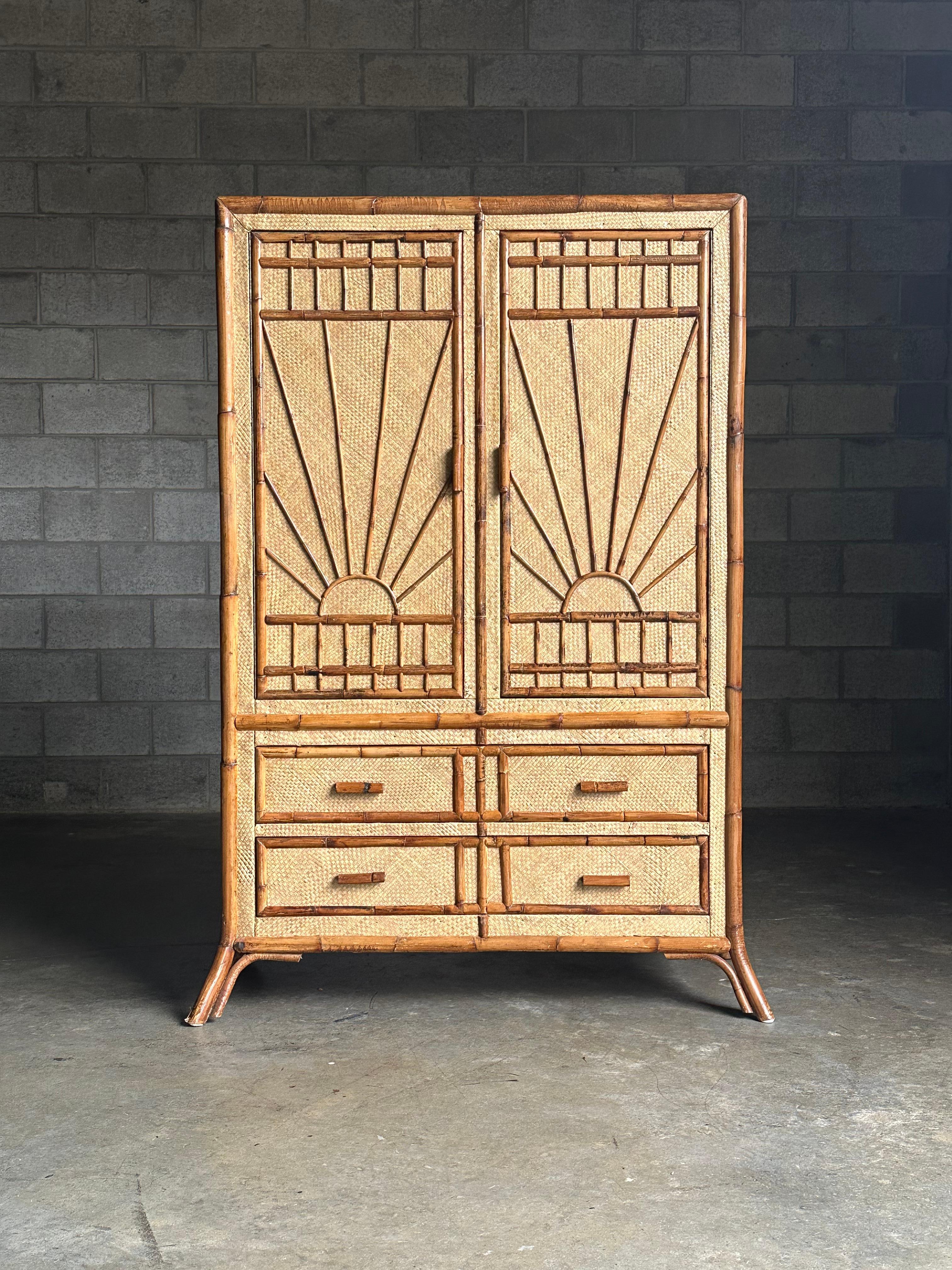 A wonderful British colonial or coastal boho chic armoire/ tall chest executed in bamboo and grass cloth. Features splayed legs and sun like pattern. Ample storage makes this every bit as functional as attractive.

Listed dimensions include splayed