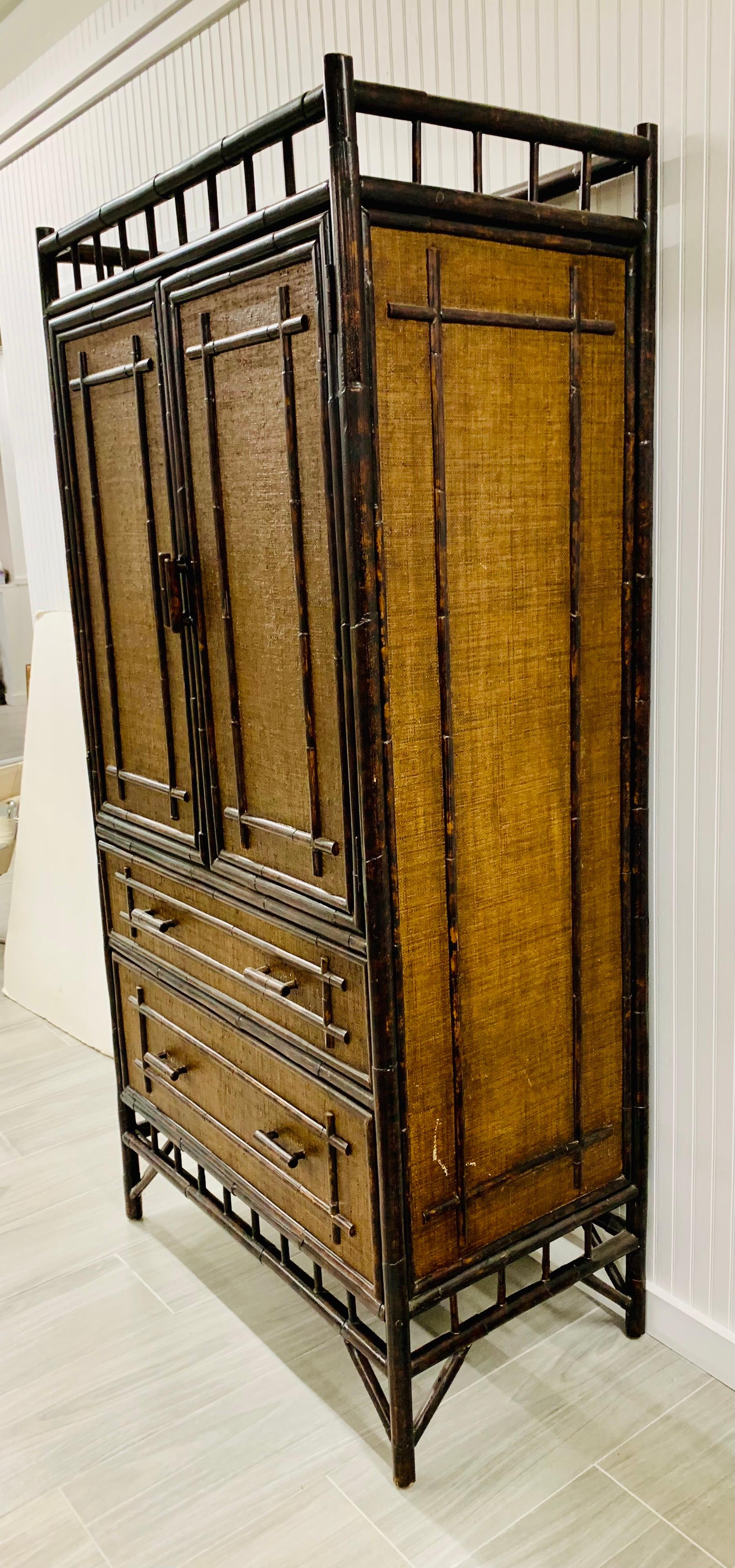 Vintage bamboo chinoiserie style armoire with rattan covered two doors over four drawers. Use as a wardrobe cabinet or television armoire.