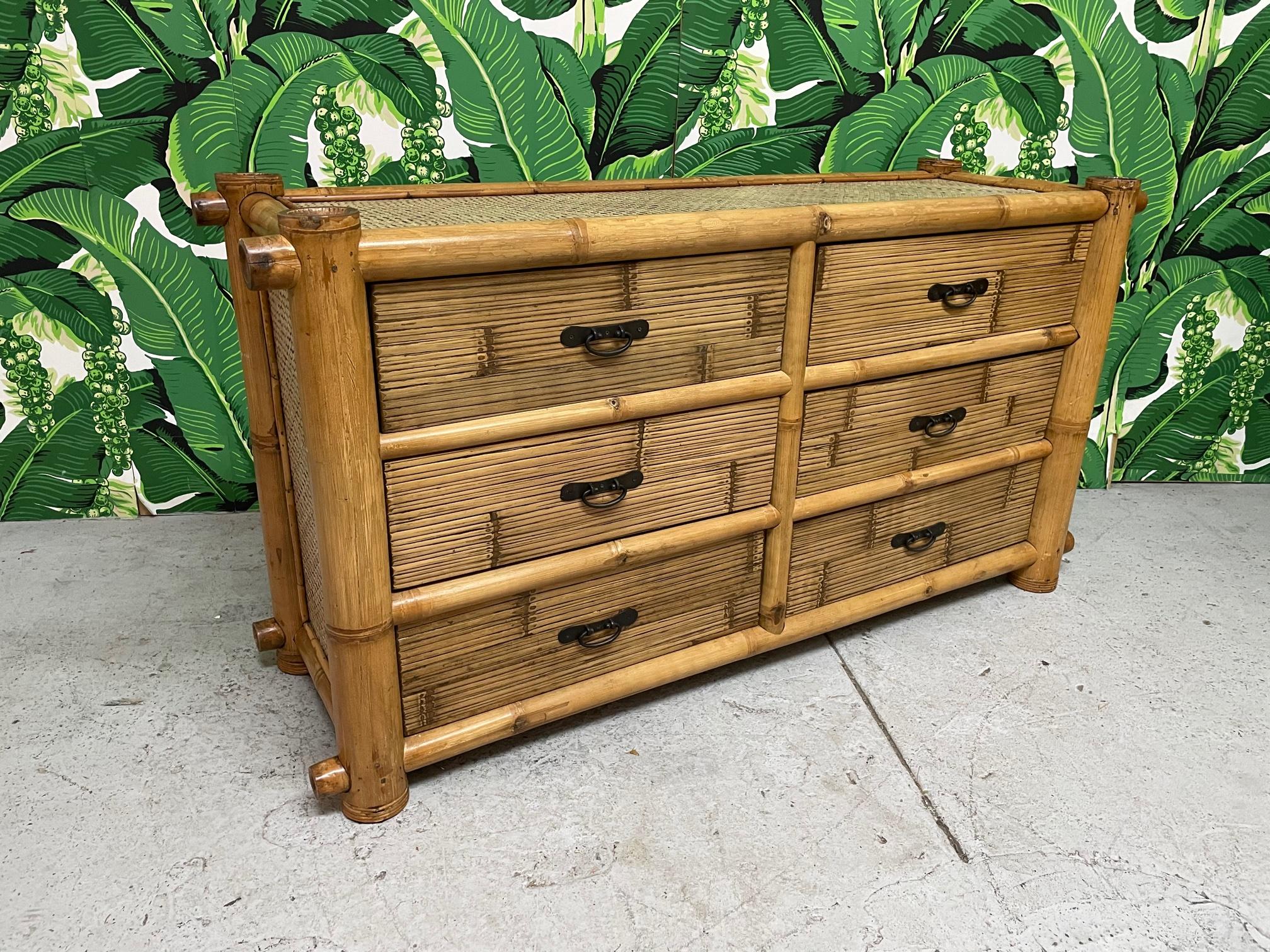 Double dresser constructed of oversized bamboo features woven rattan veneered sides and horizontal rattan veneered drawer fronts. Good vintage condition with minor imperfections consistent with age. 
 