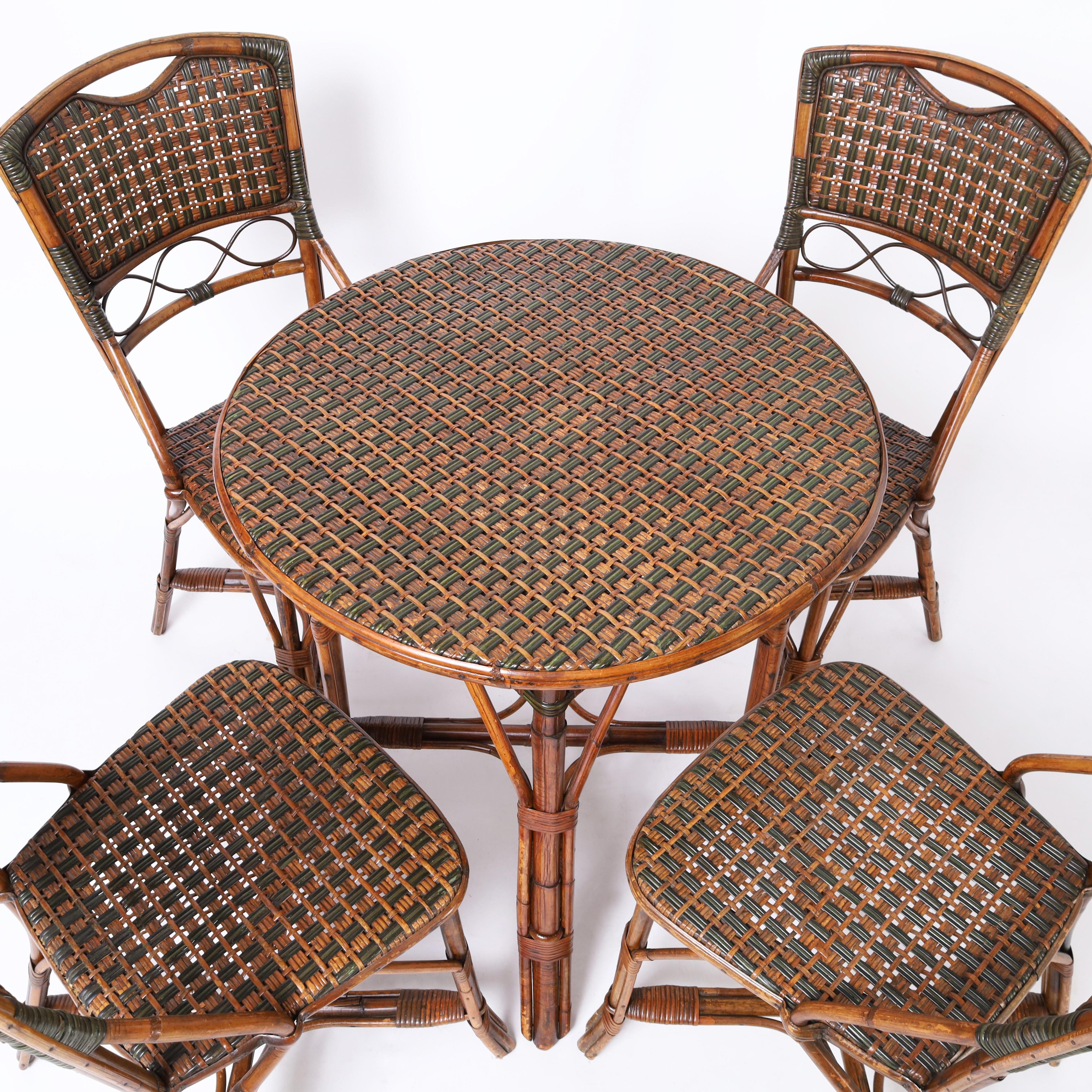 Transporting mid century French bistro round table and four chairs crafted in bamboo with rattan and painted rattan woven table top and chair seats and backs. Bon Appétit!

Table: H: 30 DM: 26
Chairs: H: 35 W: 16 D: 21
Seat: 18