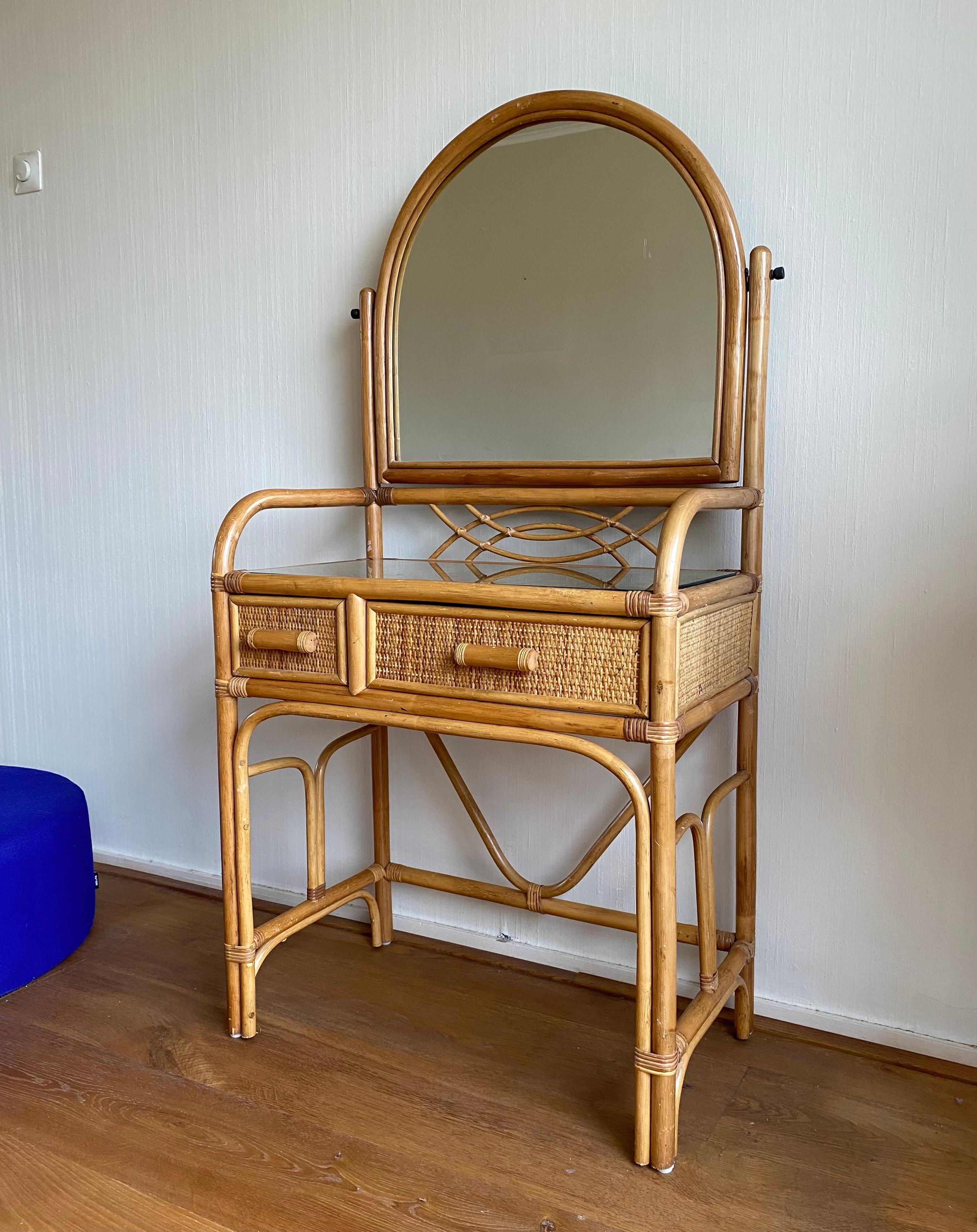 Super Cute Rattan Vanity Set From the late 20th century, consisting of a table with drawer and mirror and a stool. This European set fits well in a midcentury or Bohemian style home. Also some little princesses might like it in their room.
The set