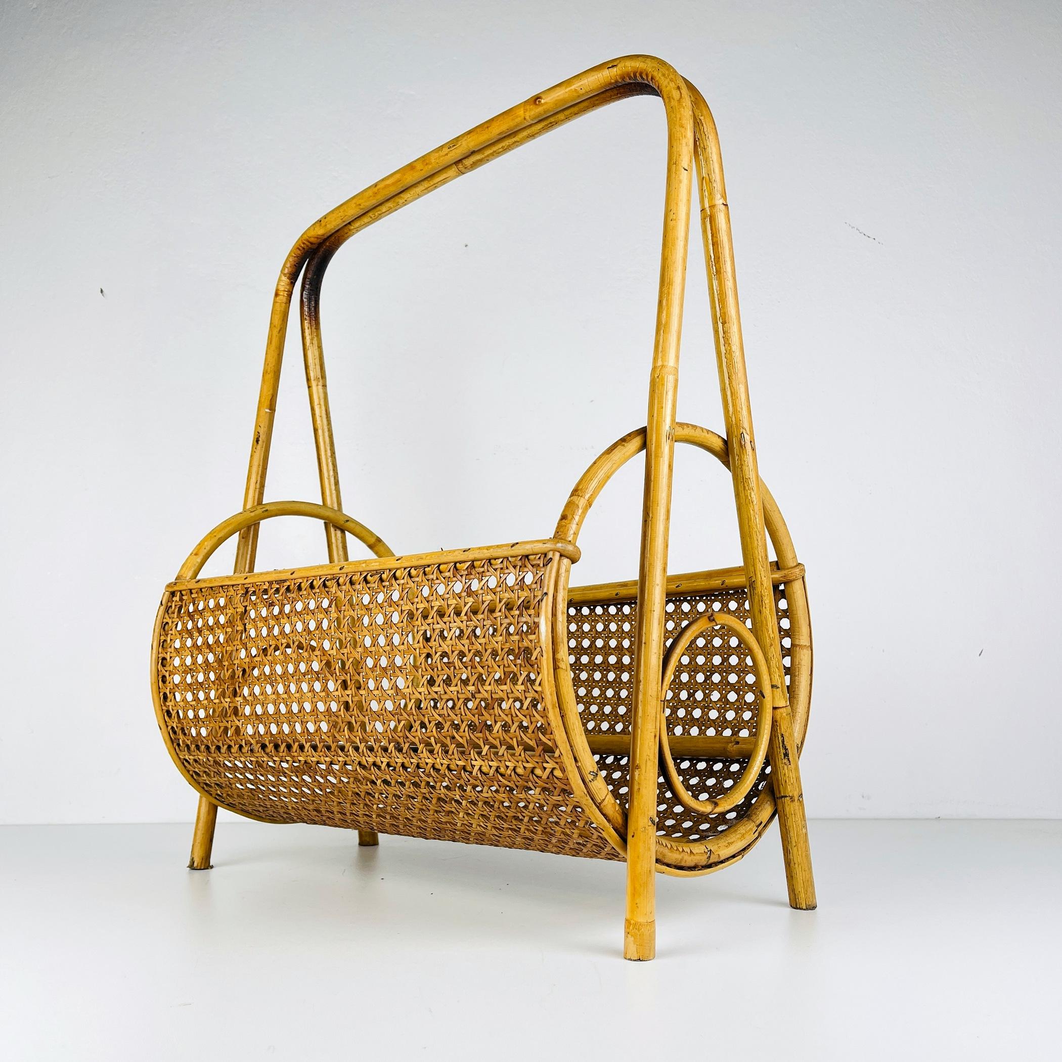 Step into the world of refined mid-century style with this stunning bamboo and rattan magazine stand. Its unique circular shape and intricate details crafted from original Vienna straw make it the perfect complement to a retro-inspired interior.