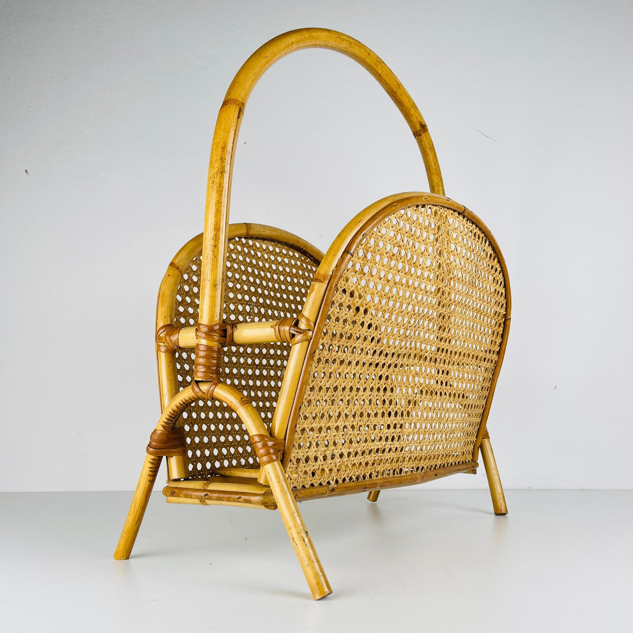 Step into the world of refined mid-century style with this stunning bamboo and rattan magazine stand. Its unique shape and intricate details crafted from original Vienna straw make it the perfect complement to a retro-inspired interior. This