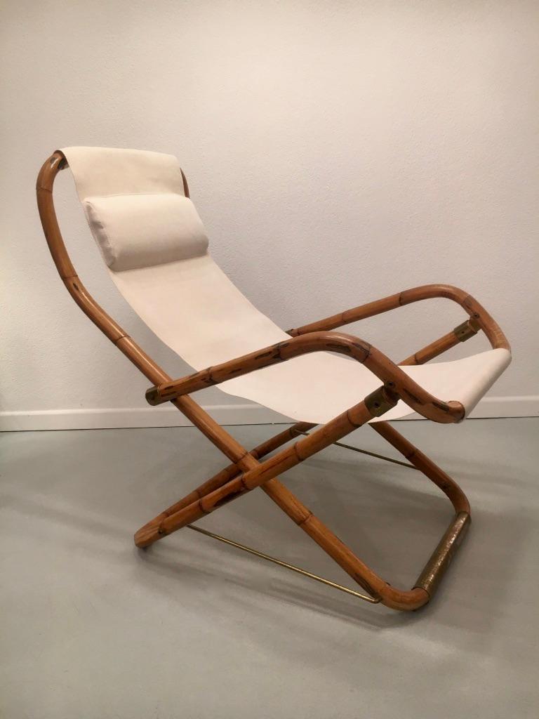 Vintage bamboo, brass and fabric folding lounge chair from Italy, circa 1960s
With integrated cushion. Original cleaned fabric.
Measures: H 95 x W 65 x D 100 cm.