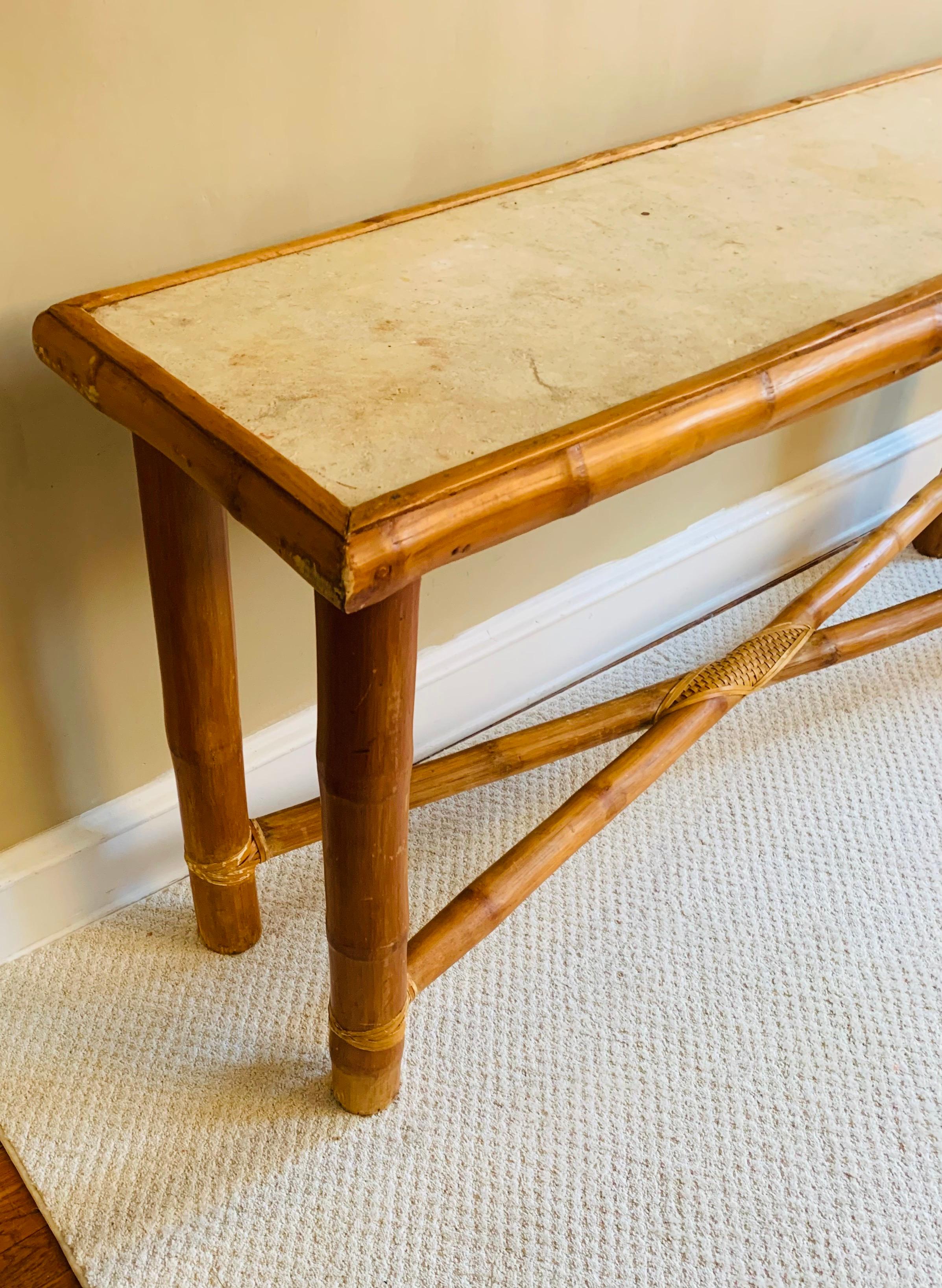 Thick substantial console table in natural-hued bamboo.

Expertly made, presumably in Burma by the thick bamboo that was used.

Raw stone top, time-worn beautifully to retain a rustic look.

It’s a sturdy, strong piece.