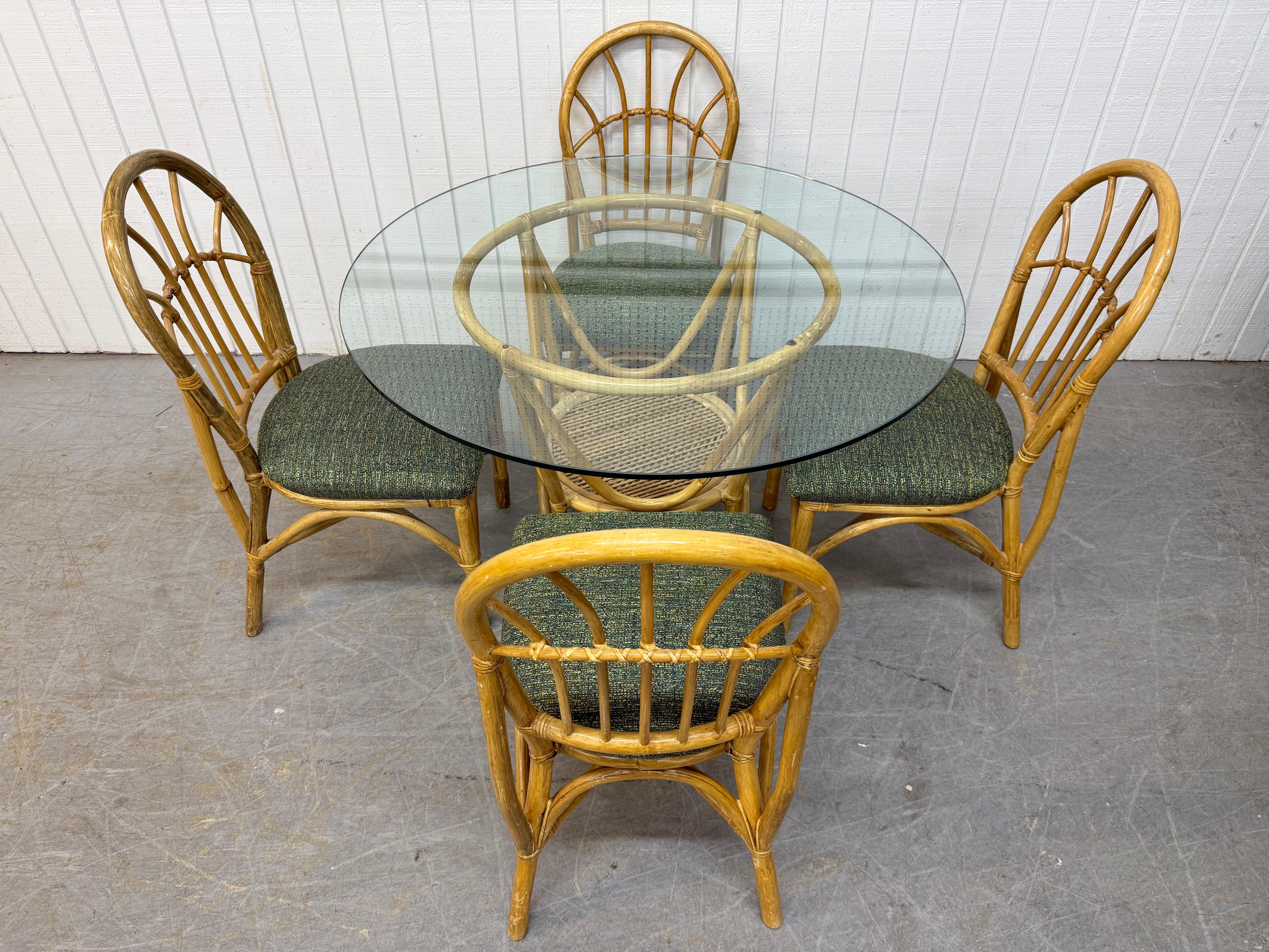 This listing is for a five piece set including a Vintage Bamboo Glass Dining Table & four side chairs. Featuring a round glass table, bamboo base, four side chairs with bamboo frames, and new green upholstery. This is an exceptional combination of