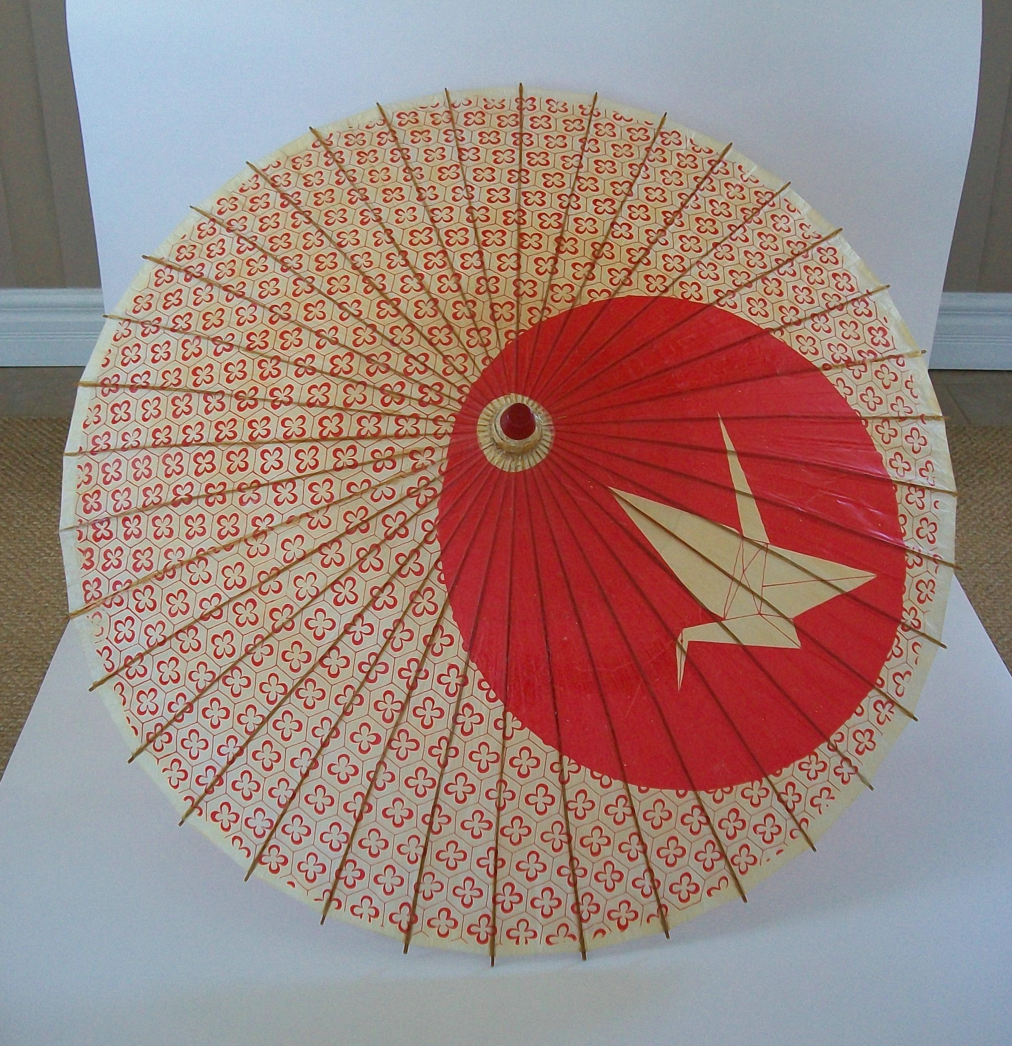 Vintage bamboo and oiled paper Wagasa umbrella or parasol - large size - hand made - featuring an Orizuru (origami folded crane) print against a red circle - overall printed textile pattern - split bamboo structure - gloss varnished finish - signed