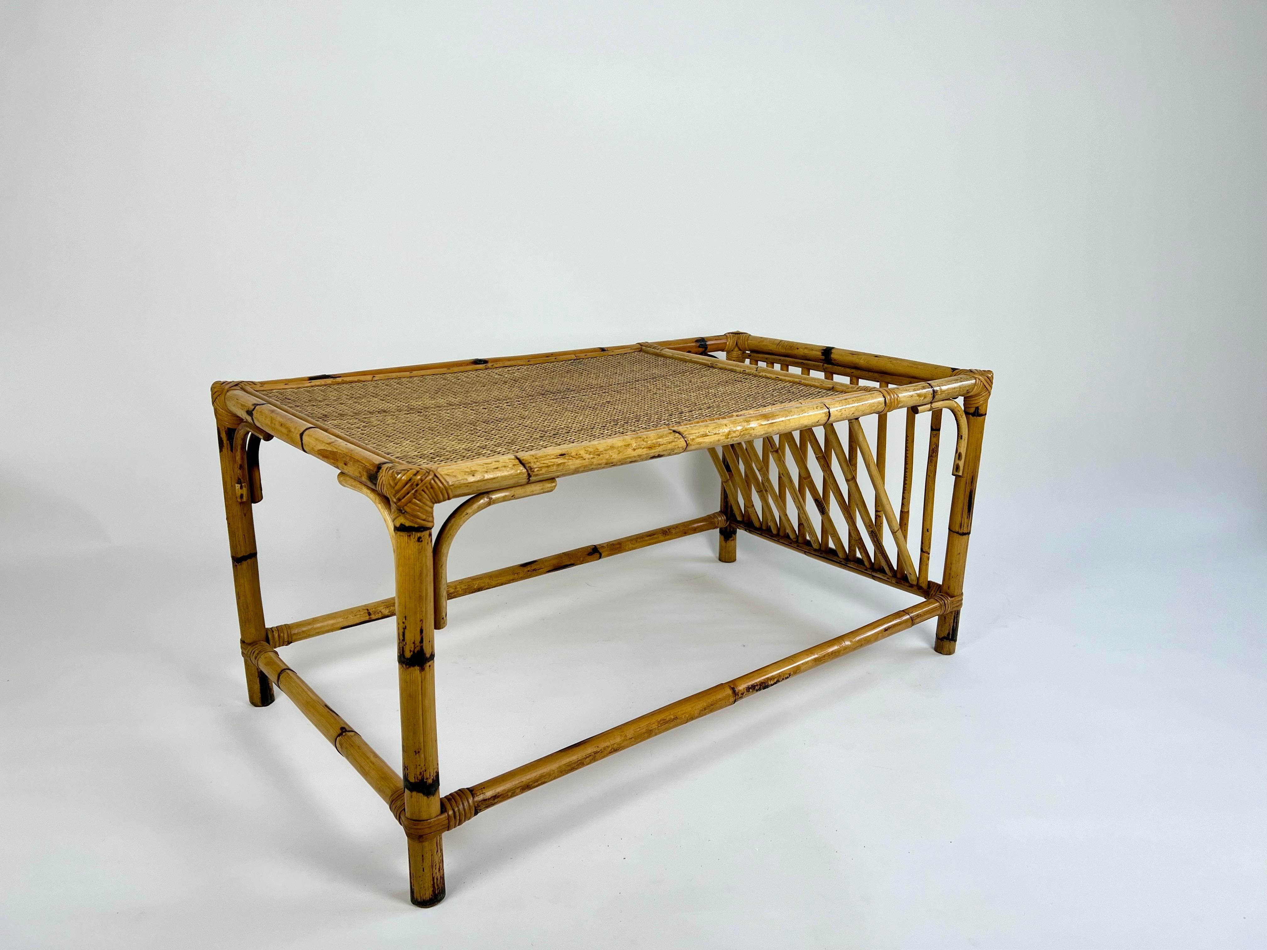 Stylish vintage coffee table with magazine rack in the manner of Vivai del Sud, sourced from Italy.

Bamboo frame with rattan top with great aged colour.

The table is sturdy with no damage or missing parts. Cleaned, ready for use.

Worldwide