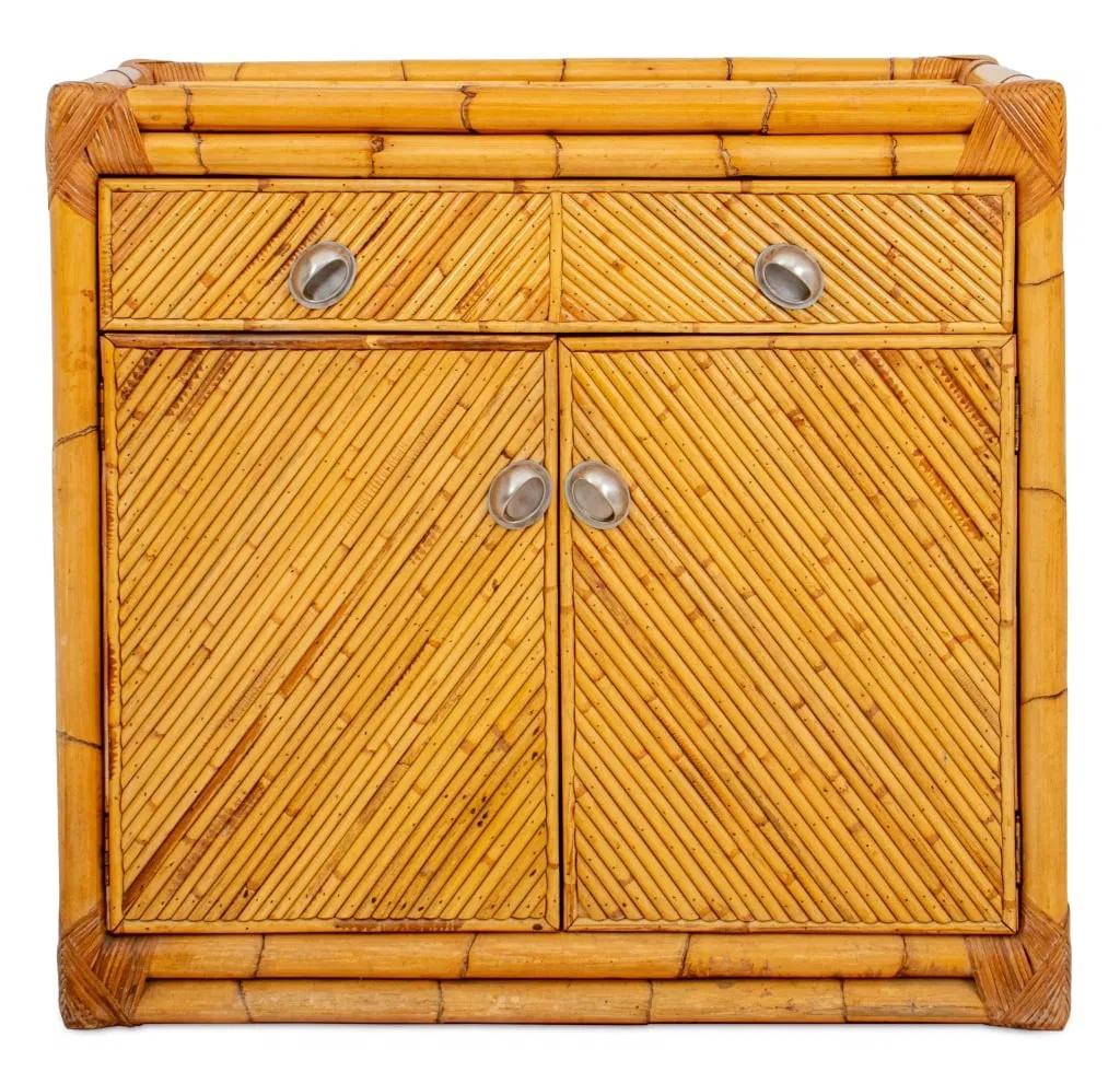 A vintage bamboo and rattan two-door cabinet attributed to Gabriella Crespi, featuring diagonally matched bamboo paneling and a sleek, modern silhouette. This Mid-Century Modern piece includes two pull-out drawers above double cabinet doors,