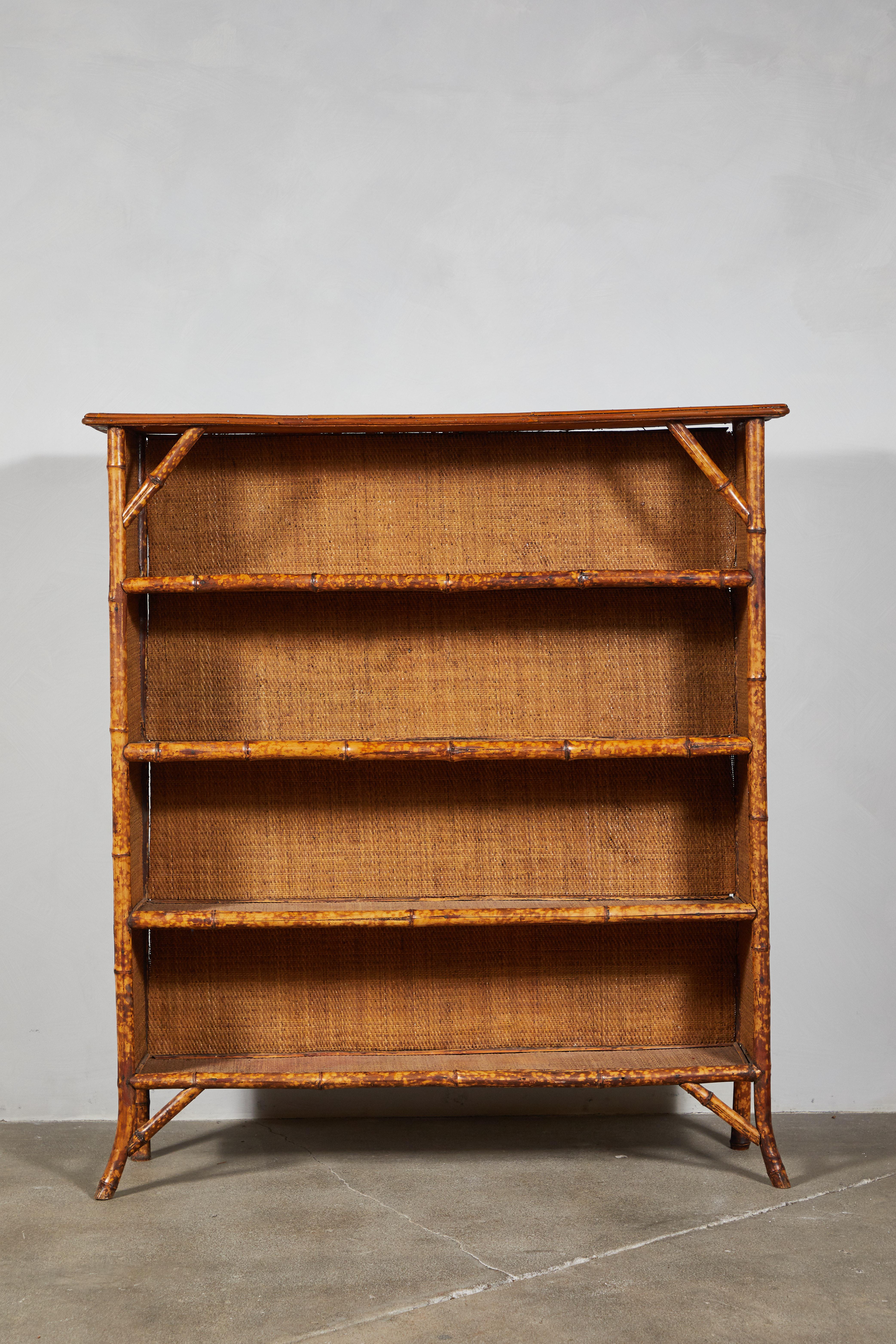Vintage three-tiered bamboo shelf with woven frame.