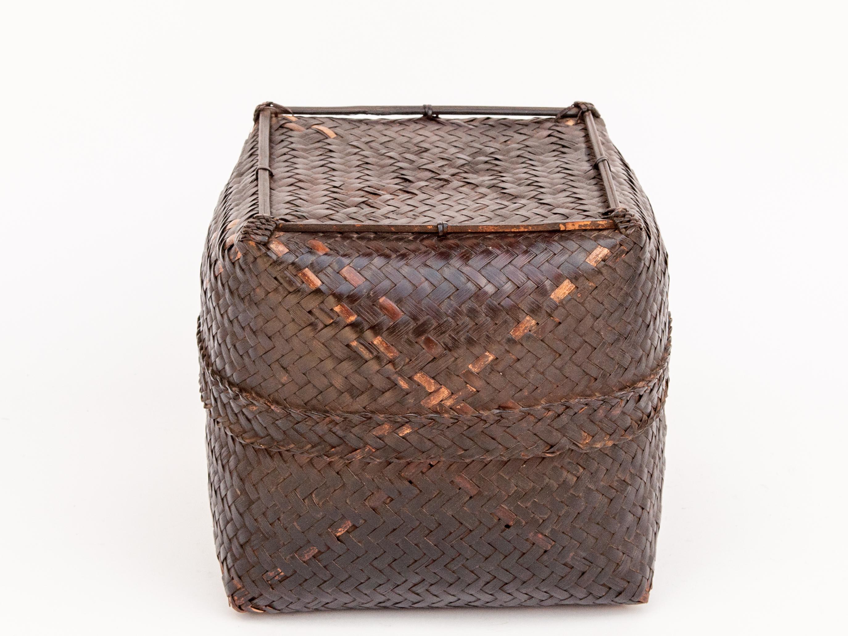 Vintage bamboo storage box basket with lid from Lombok, Indonesia, mid-late 20th century.
This sturdy bamboo basket was fashioned by hand and used to store household items and keepsakes. It is simply conceived and cleanly worked; and exhibits a
