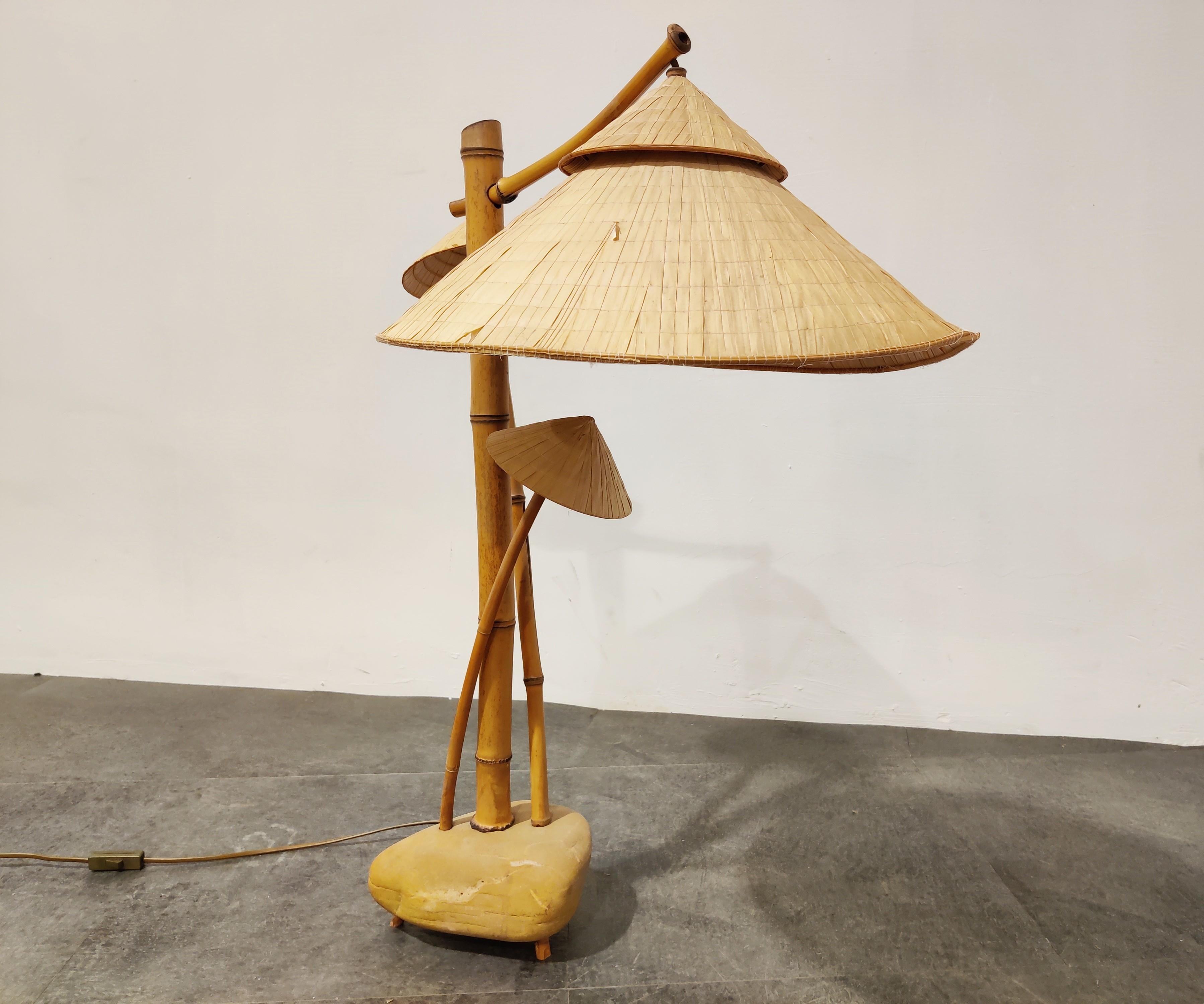 Unique bamboo table lamp with rice paper shades mounted on a clay base.

Lovely design and the lamp emits a beautiful dim light. 

1980s, Japan

Dimensions:
Height 80cm/31.49